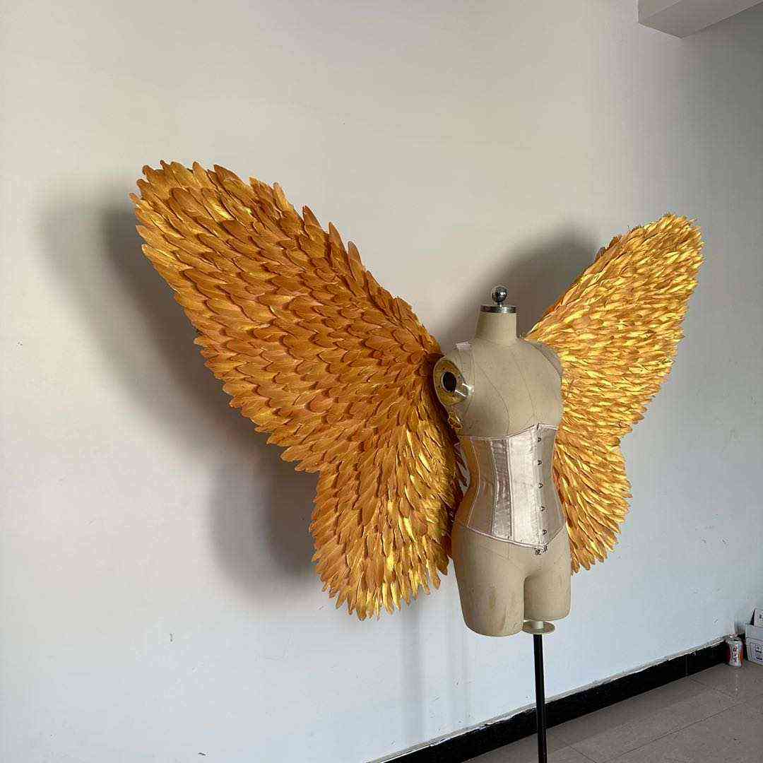 Our golden color butterfly wings from the right side. Made from goose feathers. Wings for butterfly, pixie, and fairy costumes. Suitable for photoshoots.