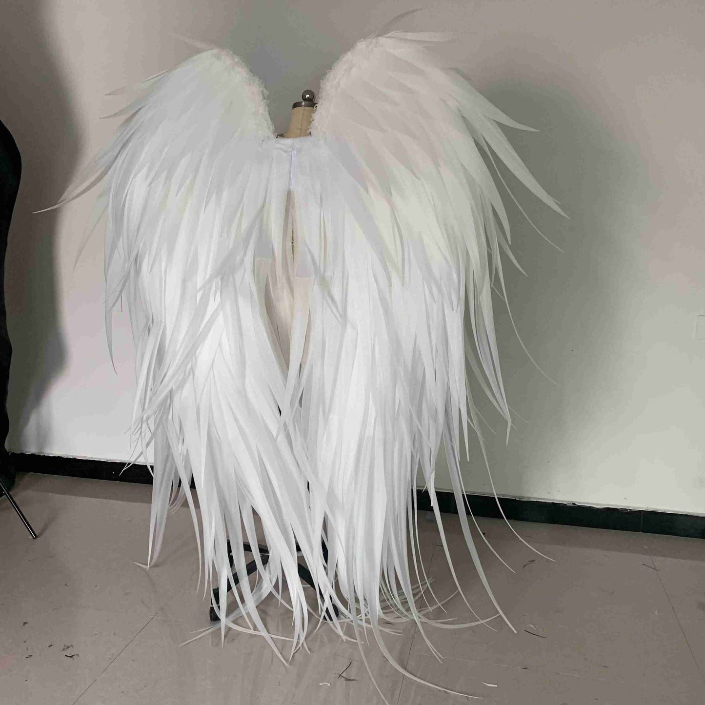 Our white angel wings from the back. Made from pearl cotton foam and some goose feathers. Wings for angel costume. Suitable for photoshoots.