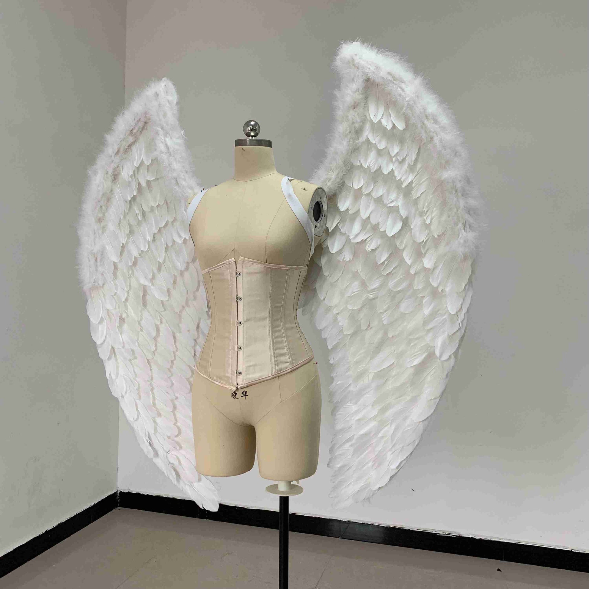Our small white color angel wings from the left side. Made from goose feathers. Wings for angel costume. Suitable for photoshoots.