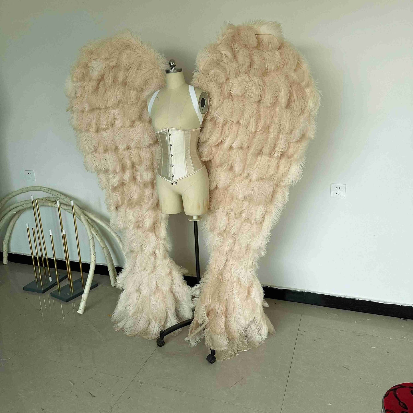 Our luxury beige angel wings from the left side. Made from ostrich feathers. Wings for angel costume. Suitable for photoshoots especially for boudoirs.