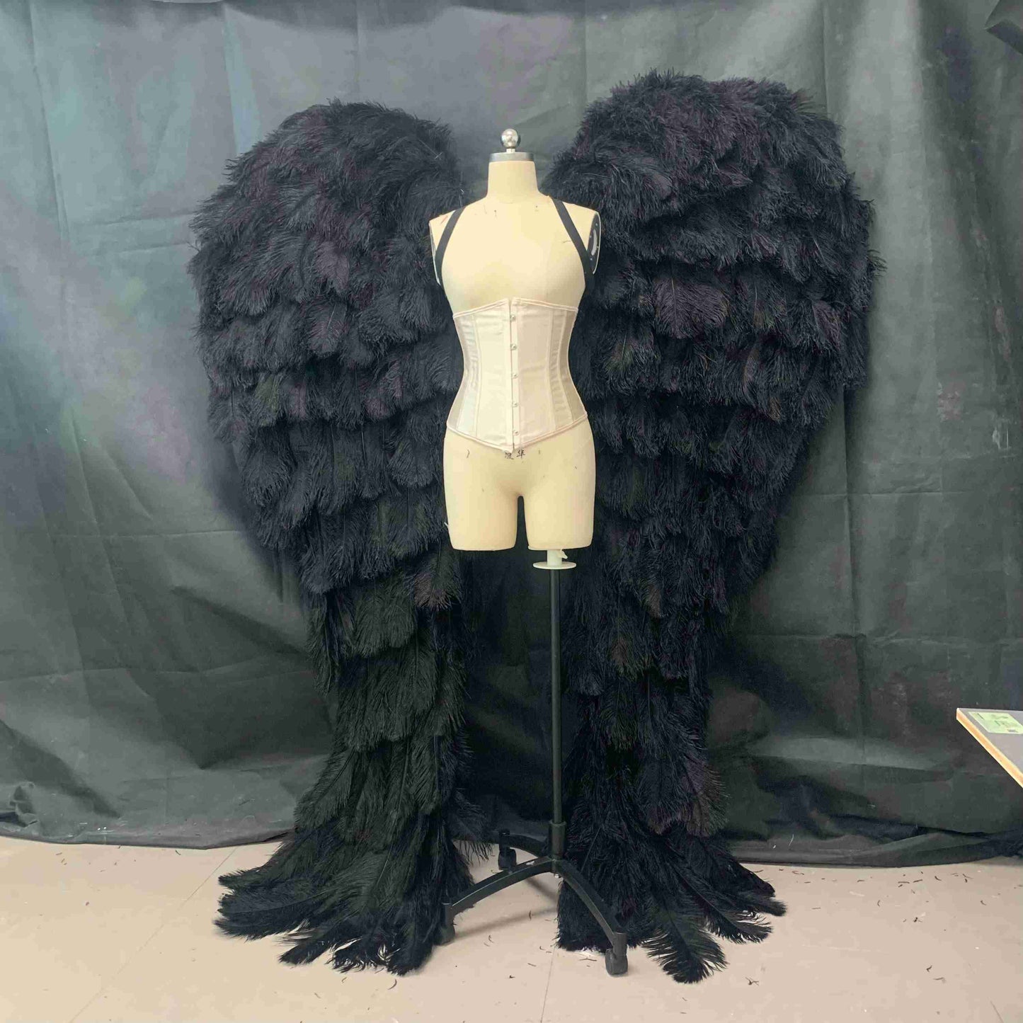 Our luxury black angel wings from the front. Made from ostrich feathers. Wings for angel costume. Suitable for photoshoots especially for boudoirs.