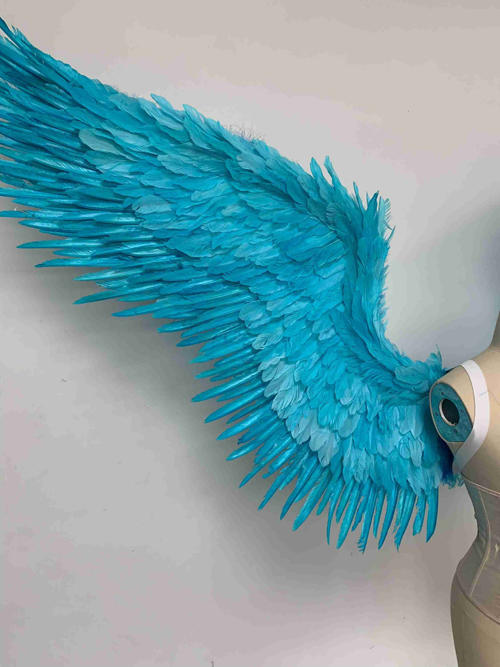 Our blue color angel wings from the close view. Made from goose feathers. Wings for angel costume or devil costume. Suitable for photoshoots.