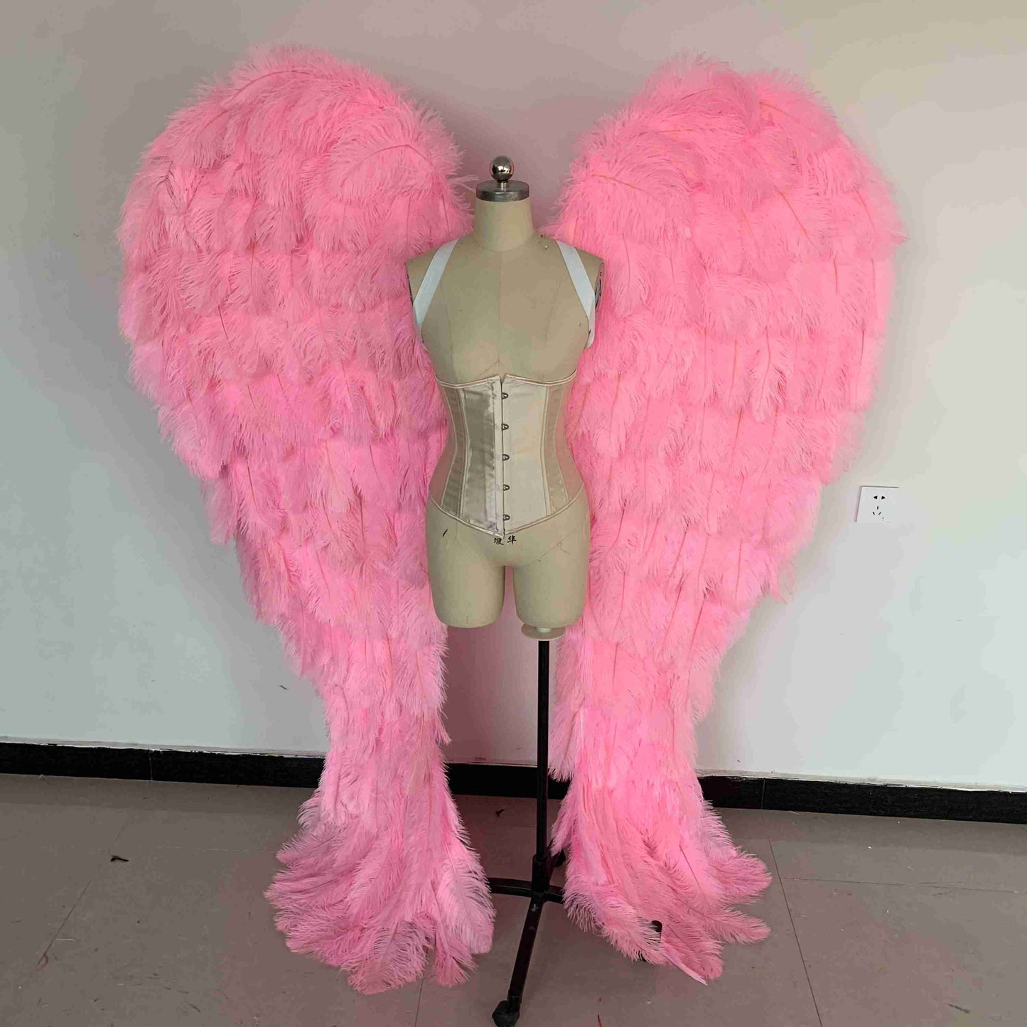 Our luxury bright pink angel wings from the front. Made from ostrich feathers. Wings for angel costume. Suitable for photoshoots especially for boudoirs.