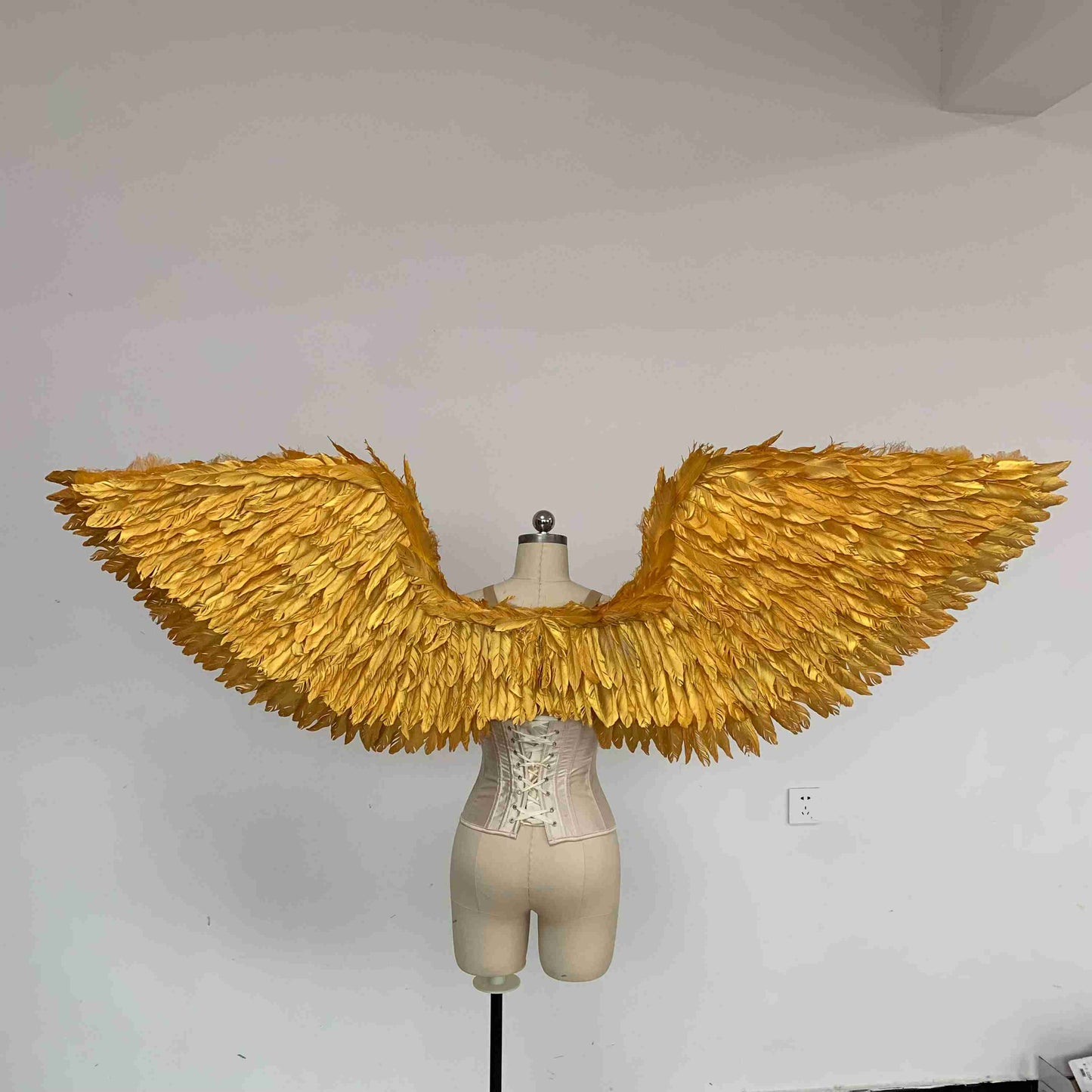 Our golden angel wings from the back. Made from goose feathers. Wings for angel costume. Suitable for photoshoots.