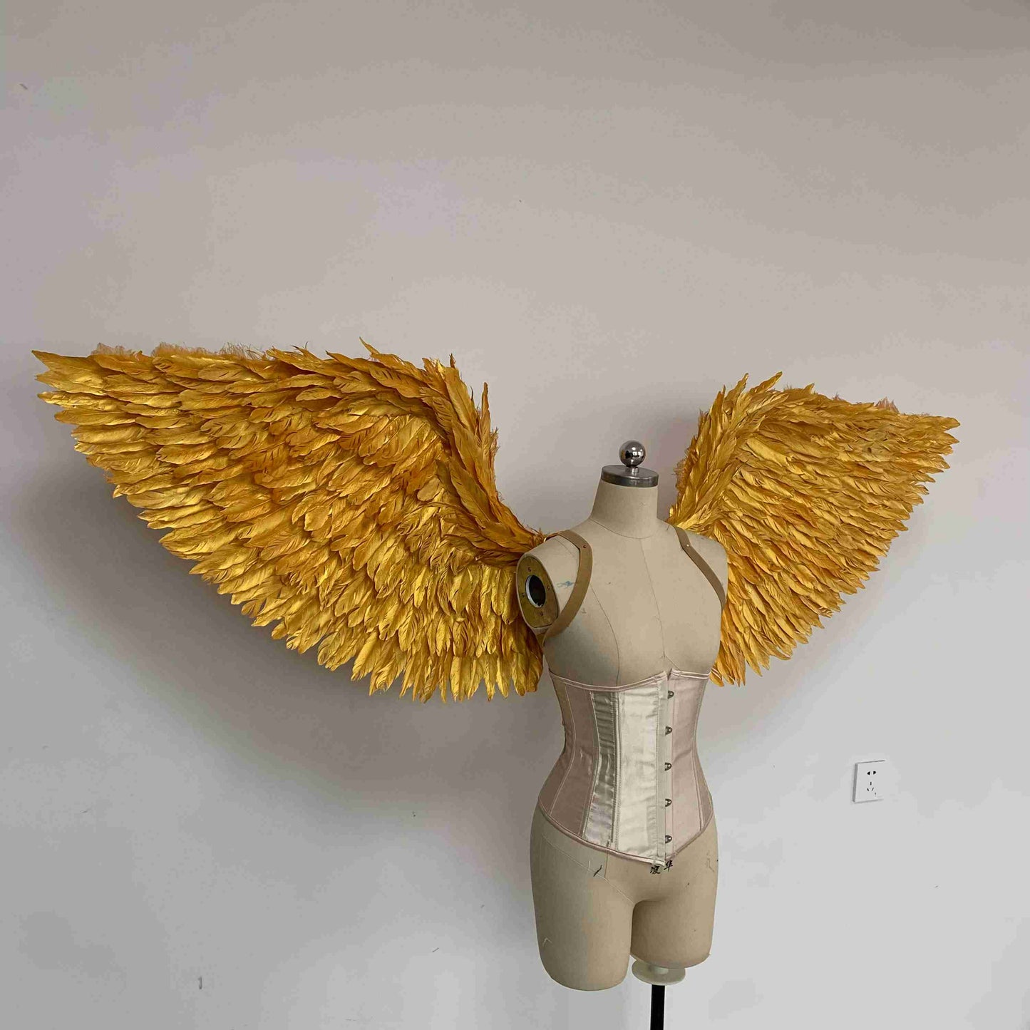 Our golden angel wings from the right side. Made from goose feathers. Wings for angel costume. Suitable for photoshoots.