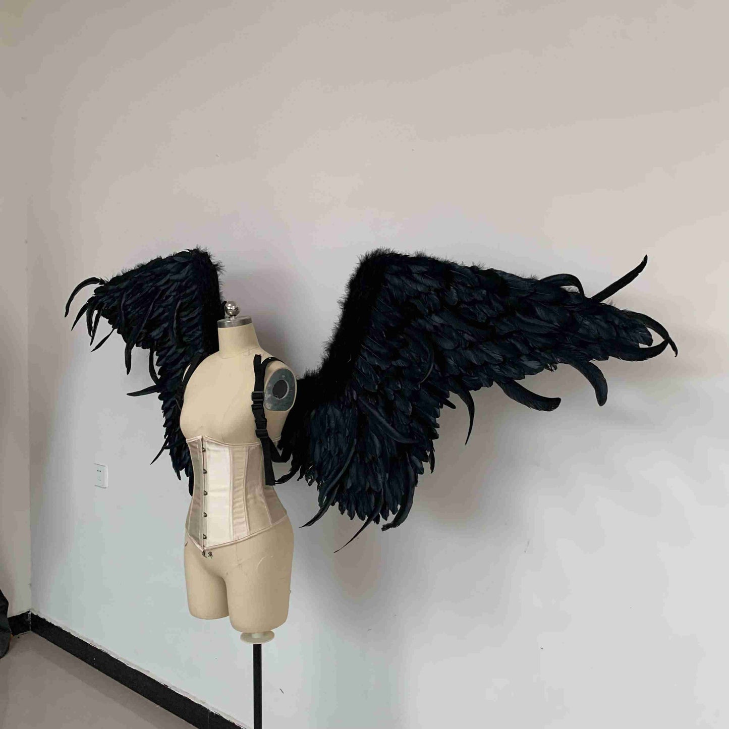 Our black color demon wings from the side. Made from goose feathers. Wings for angel costume or devil costume. Suitable for photoshoots.