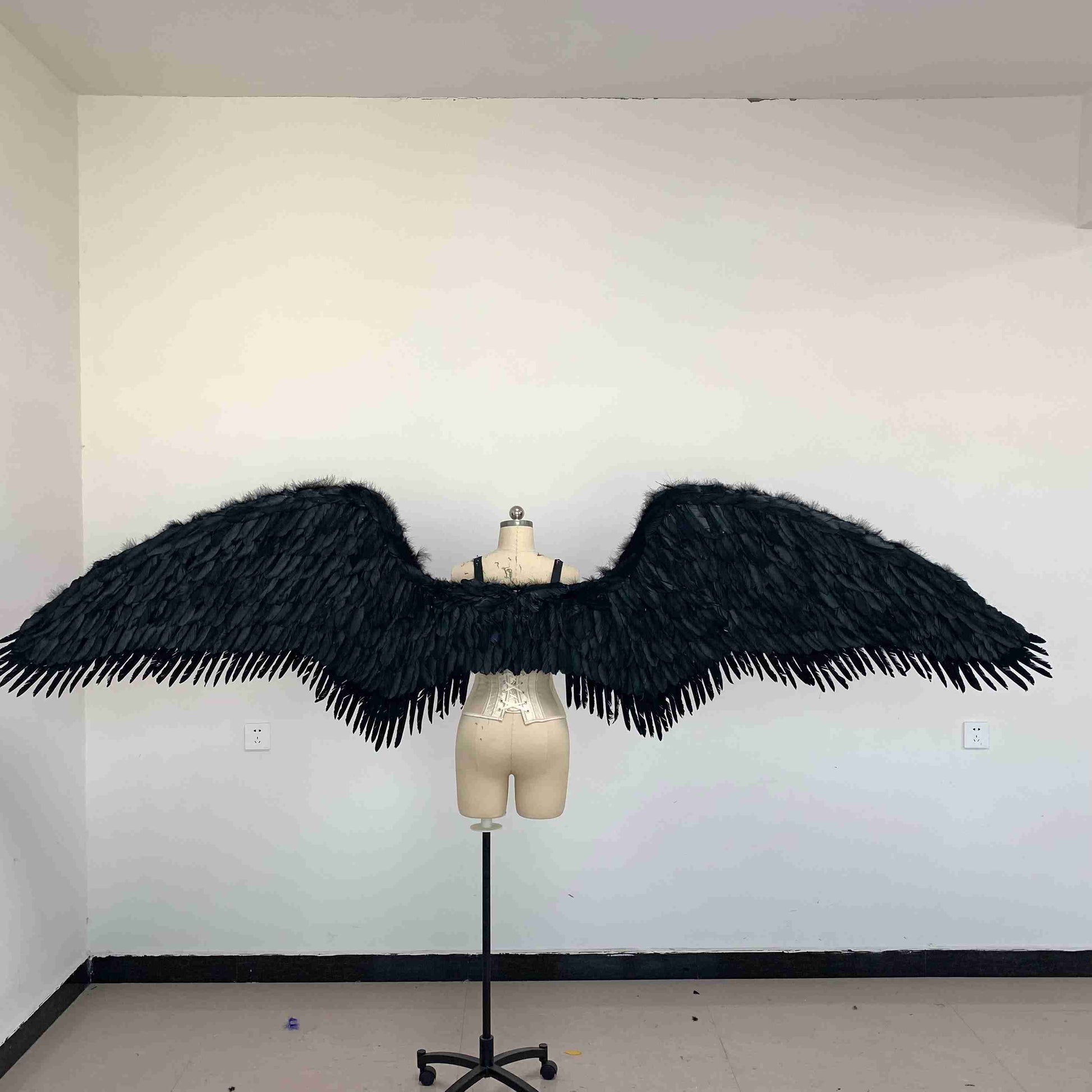Our black fallen angel wings from the back. Made from goose feathers. Wings for the devil or fallen angel costume. Suitable for photoshoots.