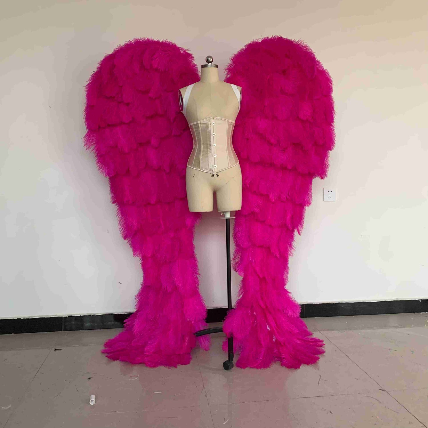 Our luxury dark pink angel wings from the front. Made from ostrich feathers. Wings for angel costume. Suitable for photoshoots especially for boudoirs.
