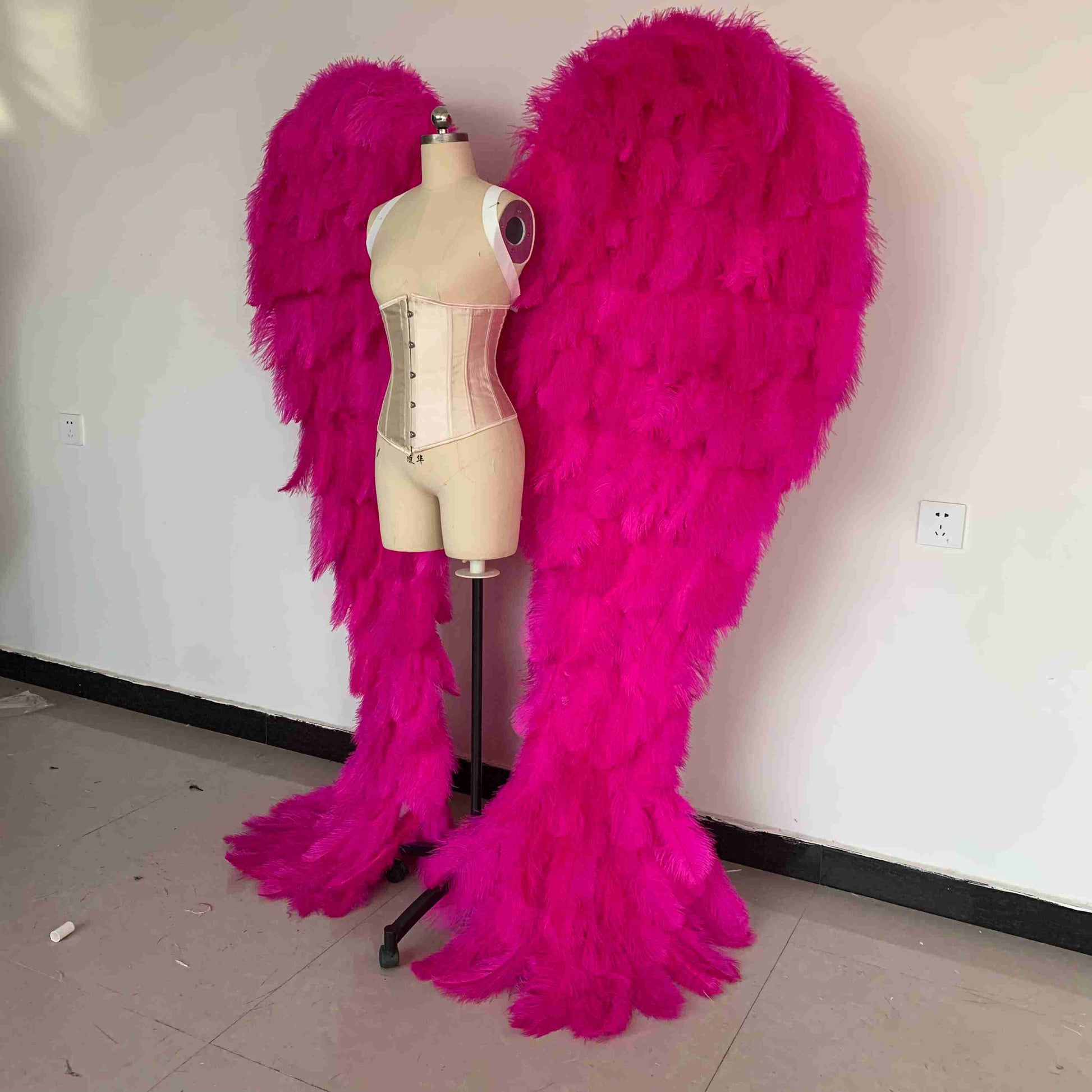 Our luxury dark pink angel wings from the left side. Made from ostrich feathers. Wings for angel costume. Suitable for photoshoots especially for boudoirs.