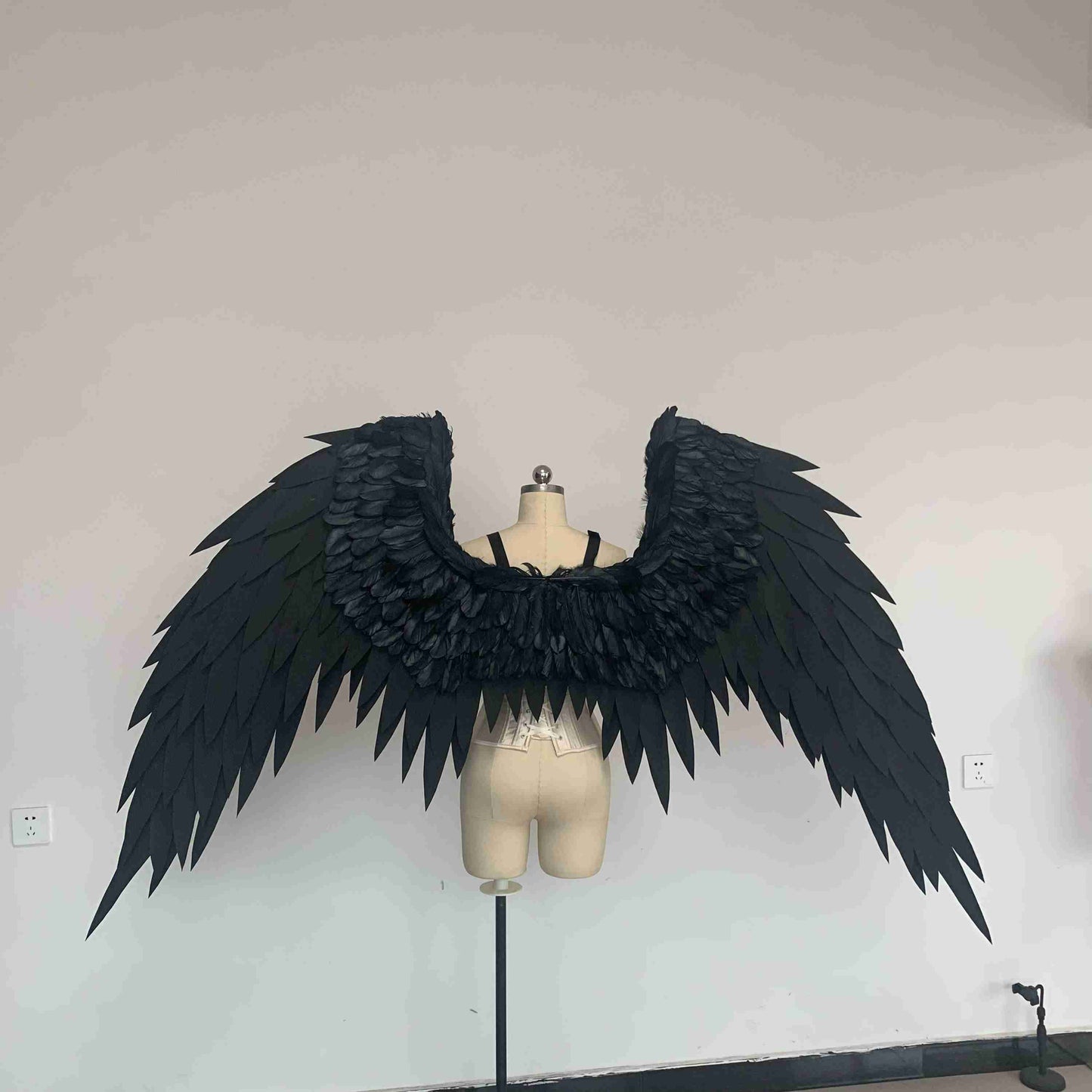 Our black color angel wings from the back. Made from EVA foam and goose feathers. Wings for angel costume or devil costume. Suitable for photoshoots.