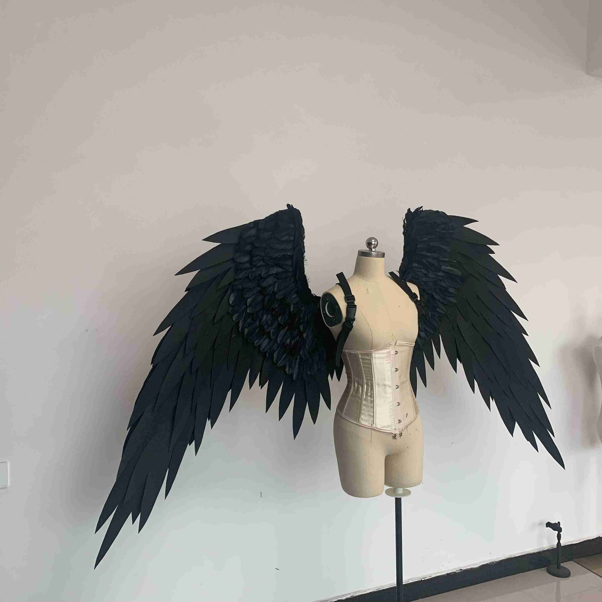 Our black color angel wings from the right side. Made from EVA foam and goose feathers. Wings for angel costume or devil costume. Suitable for photoshoots.