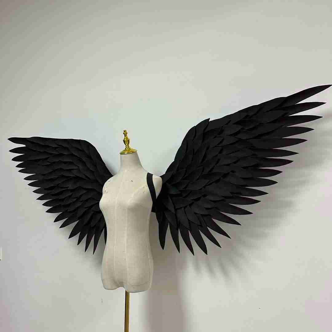 Our black angel wings from the left side. Made from EVA foam feathers. Wings for angel wings costume or devil wings costume. Suitable for photoshoots.