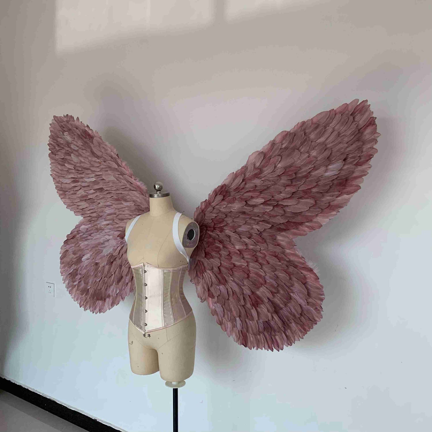 Our purple color butterfly wings from the left side. Made from goose feathers. Wings for butterfly, pixie, and fairy costumes. Suitable for photoshoots.
