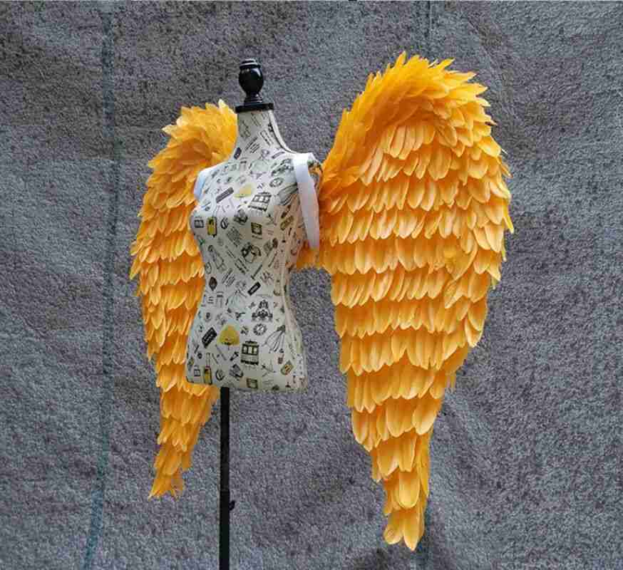 Our little gold color angel wings from the left side. Made from goose feathers. Wings for angel costume. Suitable for photoshoots.