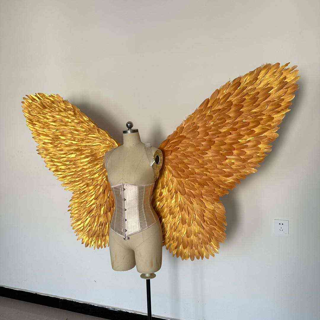 Our golden color butterfly wings from the left side. Made from goose feathers. Wings for butterfly, pixie, and fairy costumes. Suitable for photoshoots.