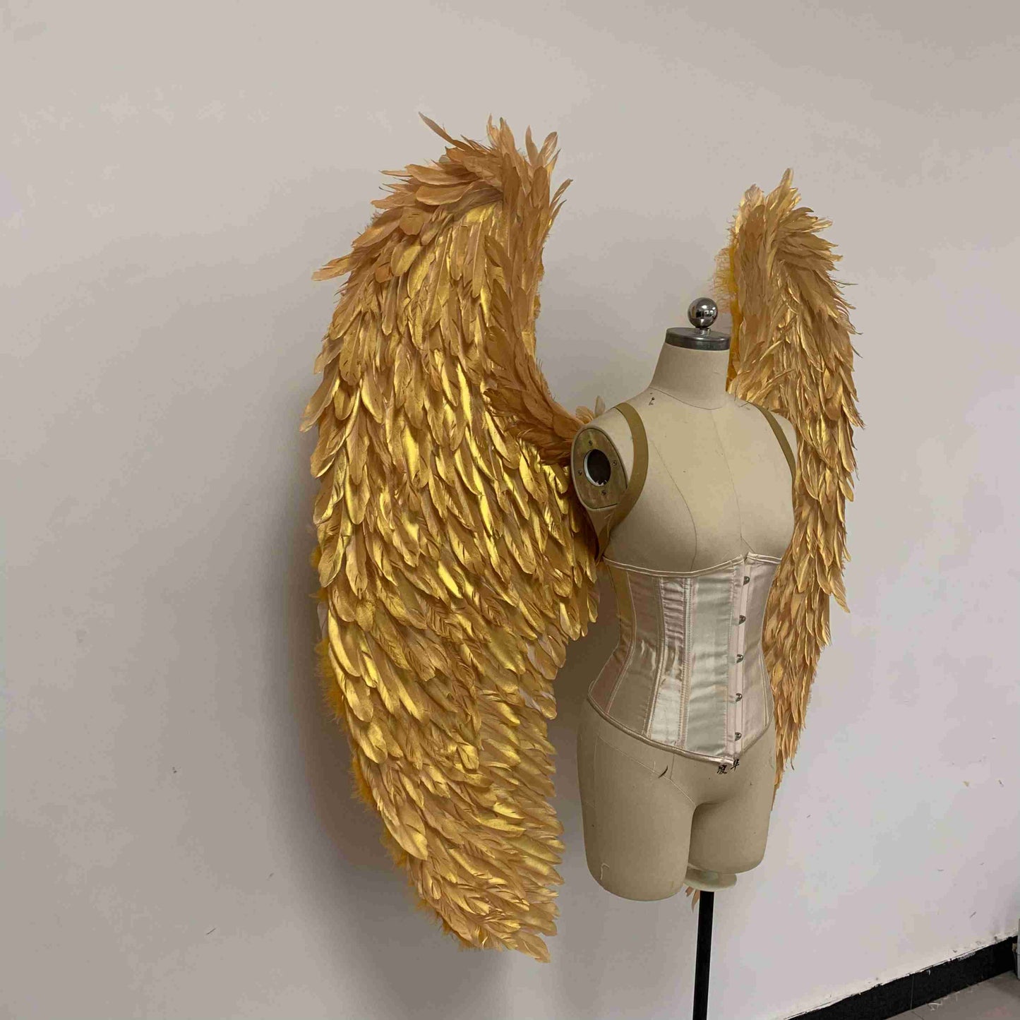 Our golden color angel wings from the right side. Made from goose feathers. Wings for angel costume. Suitable for photoshoots.