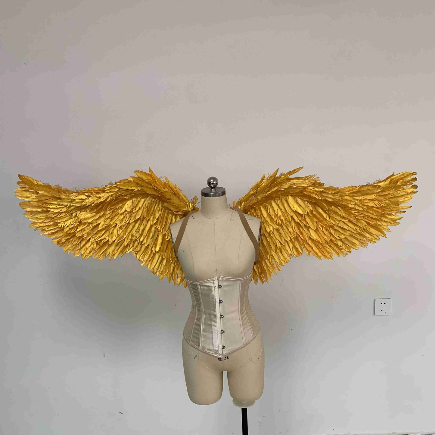 Our small golden angel wings from the front. Made from goose feathers. Wings for angel costume. Suitable for photoshoots.