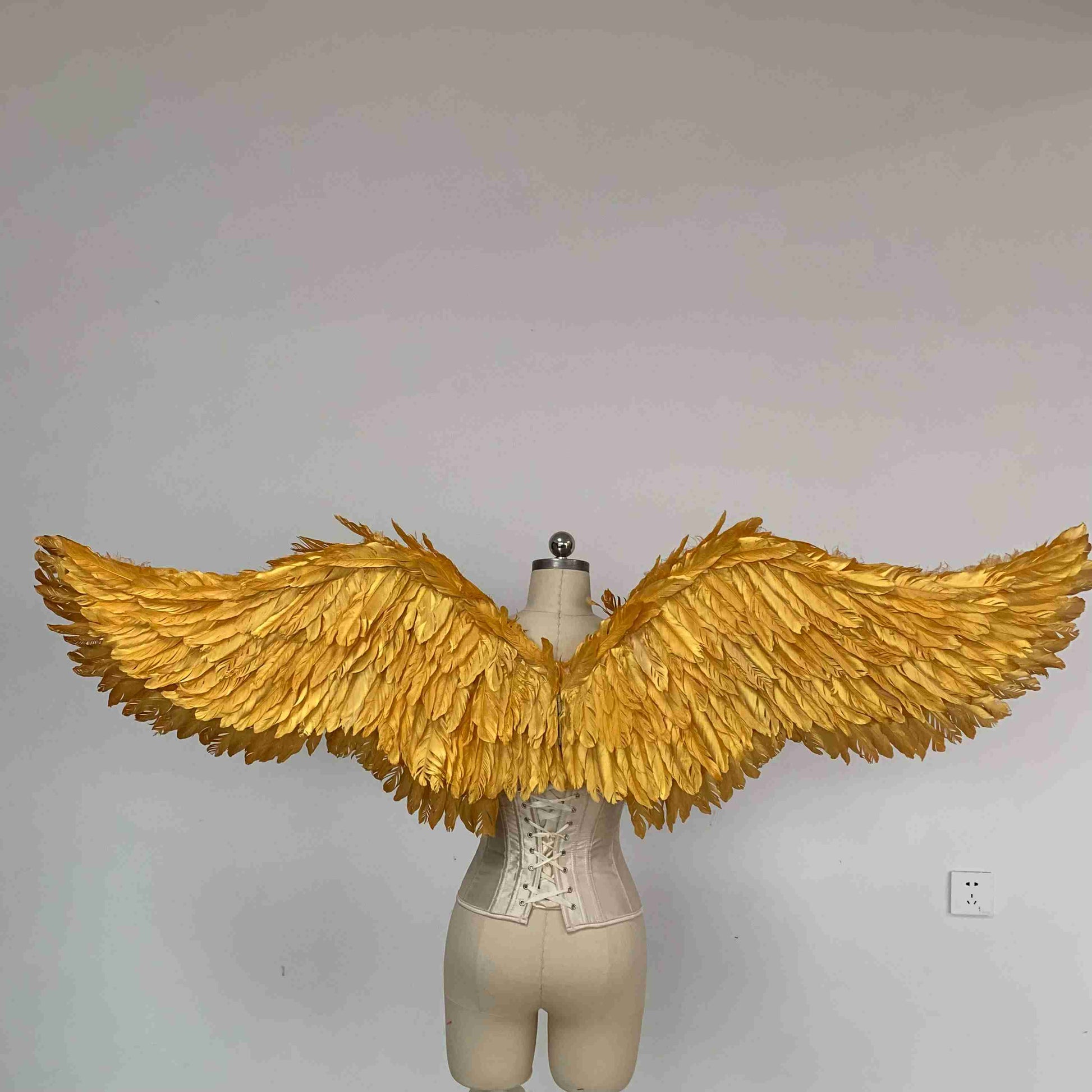Our small golden angel wings from the back. Made from goose feathers. Wings for angel costume. Suitable for photoshoots.