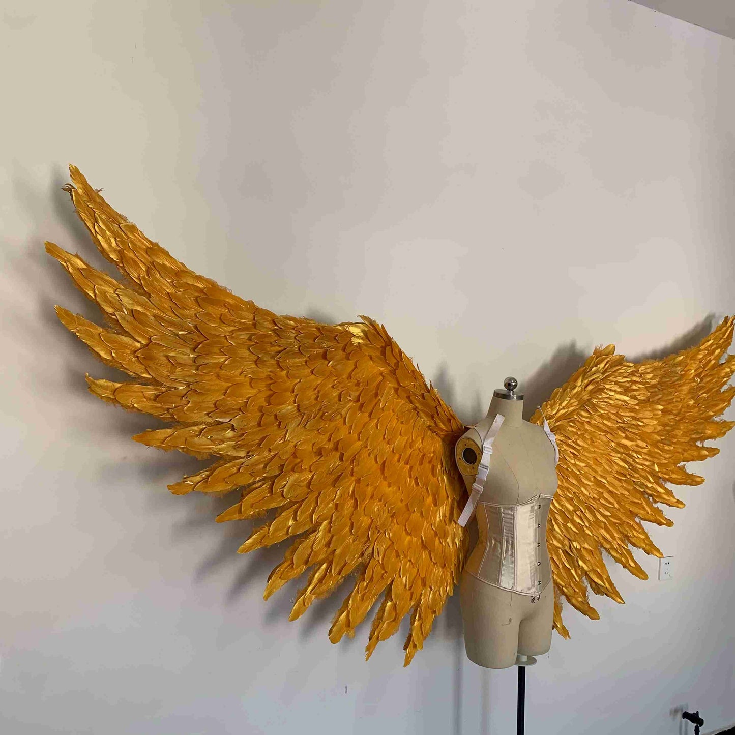 Our big golden angel wings from the right side. Made from goose feathers. Wings for angel costume. Suitable for photoshoots.
