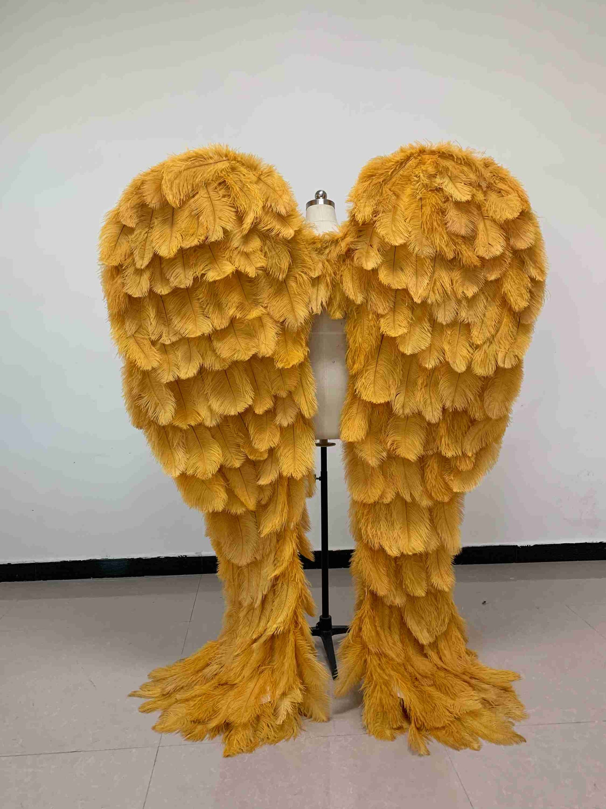 Our luxury golden angel wings from the back. Made from ostrich feathers. Wings for angel costume. Suitable for photoshoots especially for boudoirs.