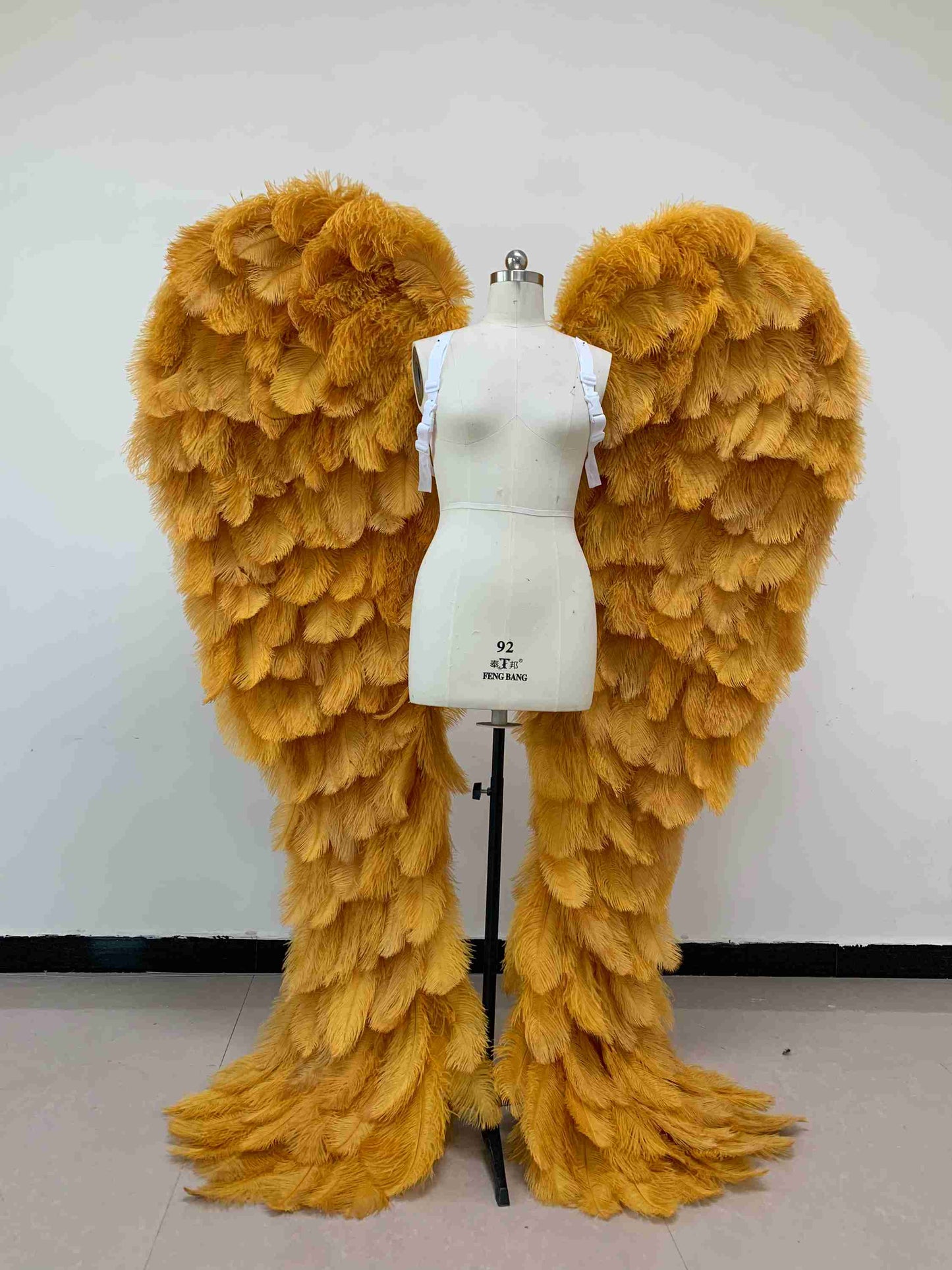 Our luxury gold angel wings from the front. Made from ostrich feathers. Wings for angel costume. Suitable for photoshoots especially for boudoirs.