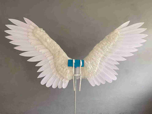 Our large white color angel wings from the front. Wings are moveable and can control extension and folding remotely. Made from flannel cloth and goose feathers. Wings for angel costume or devil costume. Suitable for fantasy photoshoots or events.