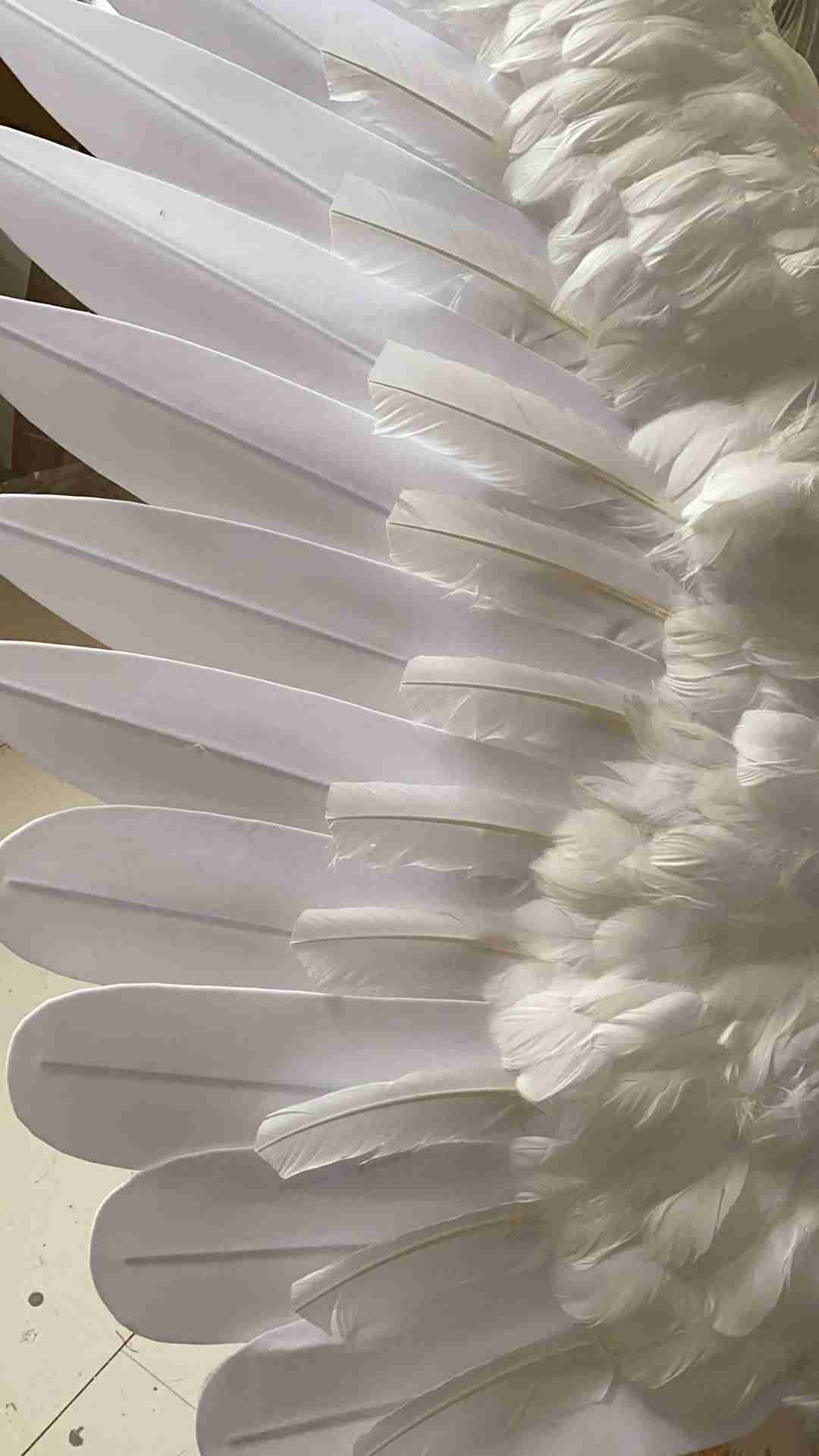 Our large white color angel wings feathers. Wings are moveable and can control extension and folding remotely. Made from flannel cloth and goose feathers. Wings for angel costume or devil costume. Suitable for fantasy photoshoots or events.