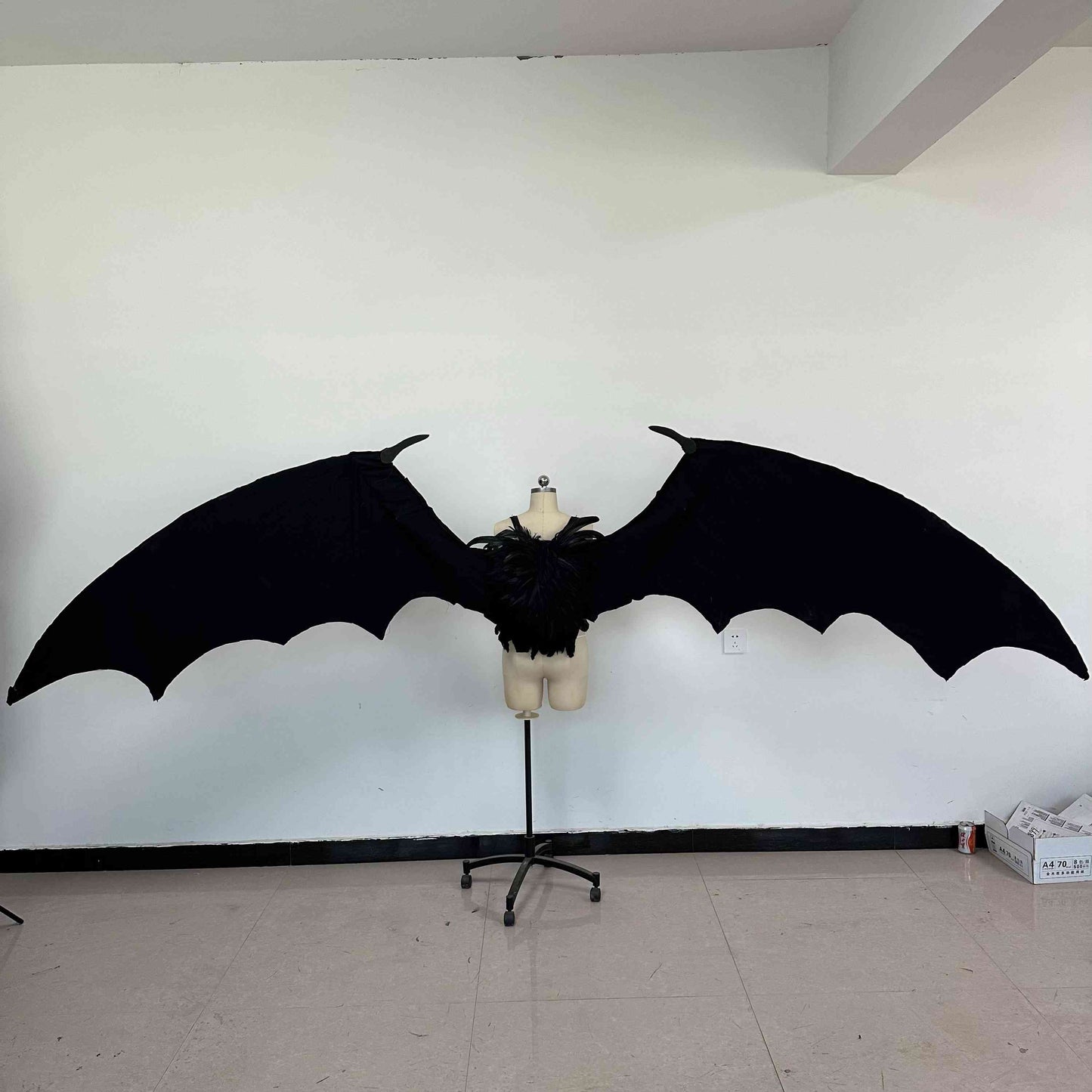 Our large black color devil wings from the back. Wings are moveable and can control extension and folding remotely. Made from aluminum alloy and cloth. Wings for fallen angel costume or devil costume. Suitable for fantasy photoshoots or events.