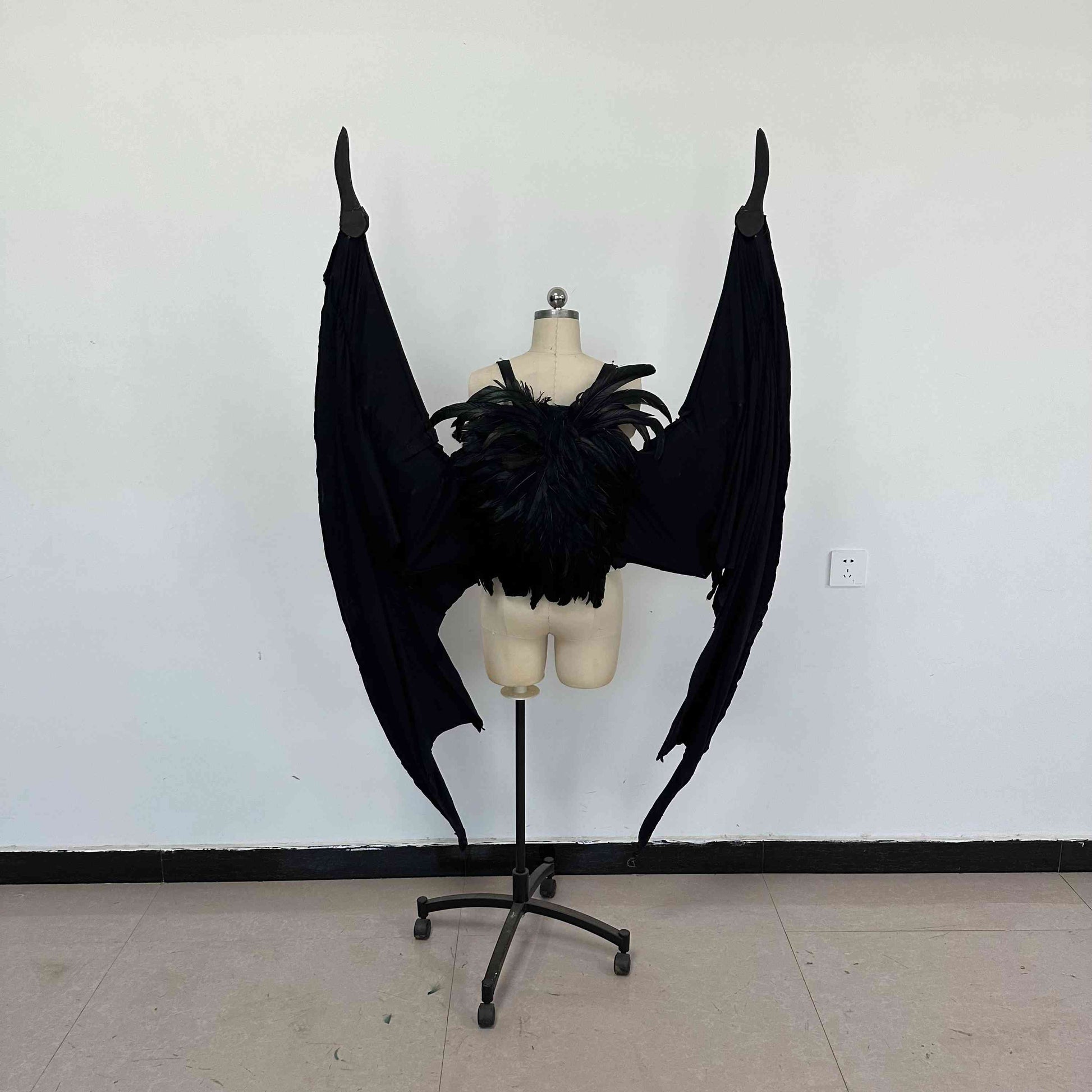 Our large black color devil wings folded from the back. Wings are moveable and can control extension and folding remotely. Made from aluminum alloy and cloth. Wings for fallen angel costume or devil costume. Suitable for fantasy photoshoots or events.