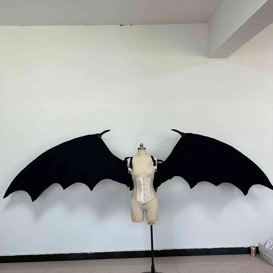 Our large black color devil wings from the front. Wings are moveable and can control extension and folding remotely. Made from aluminum alloy and cloth. Wings for fallen angel costume or devil costume. Suitable for fantasy photoshoots or events.