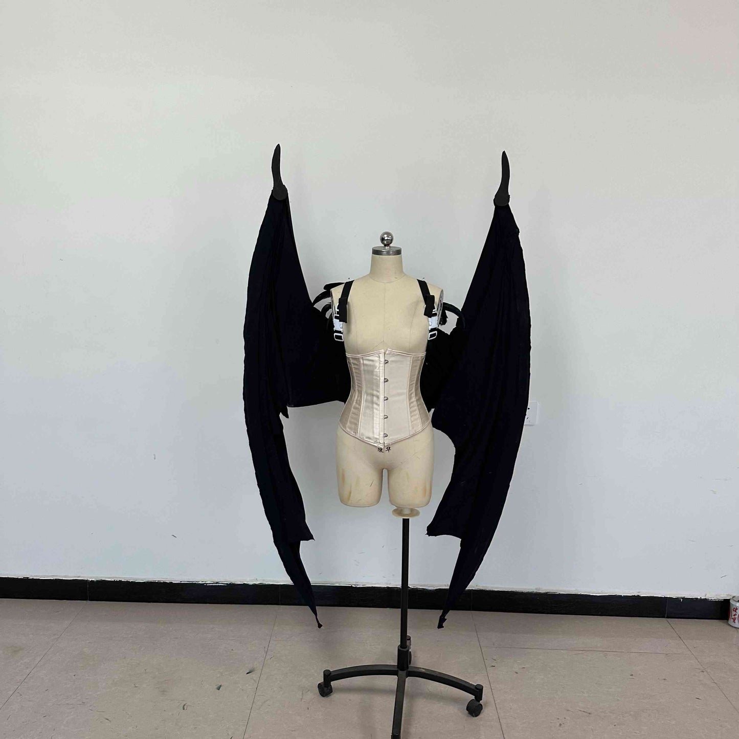 Our large black color devil wings folded from the front. Wings are moveable and can control extension and folding remotely. Made from aluminum alloy and cloth. Wings for fallen angel costume or devil costume. Suitable for fantasy photoshoots or events.