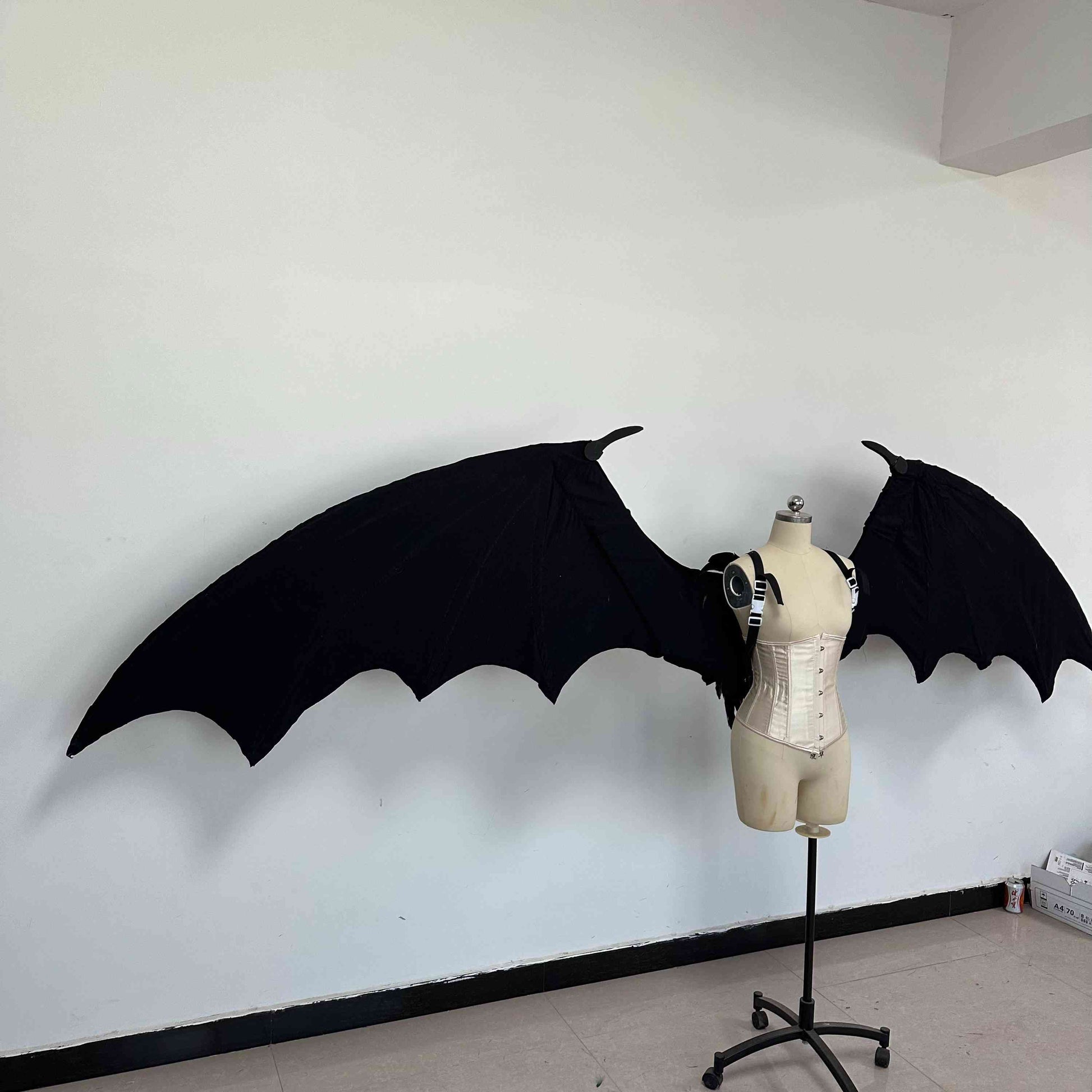 Our large black color devil wings from the right side. Wings are moveable and can control extension and folding remotely. Made from aluminum alloy and cloth. Wings for fallen angel costume or devil costume. Suitable for fantasy photoshoots or events.