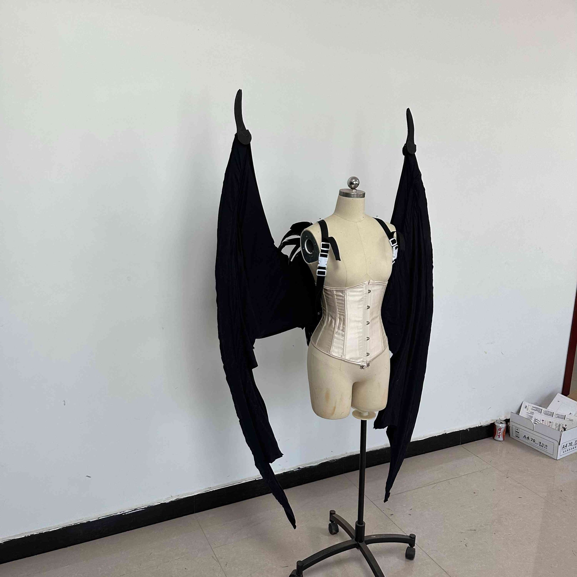 Our large black color devil wings folded from the right side. Wings are moveable and can control extension and folding remotely. Made from aluminum alloy and cloth. Wings for fallen angel costume or devil costume. Suitable for fantasy photoshoots or events.