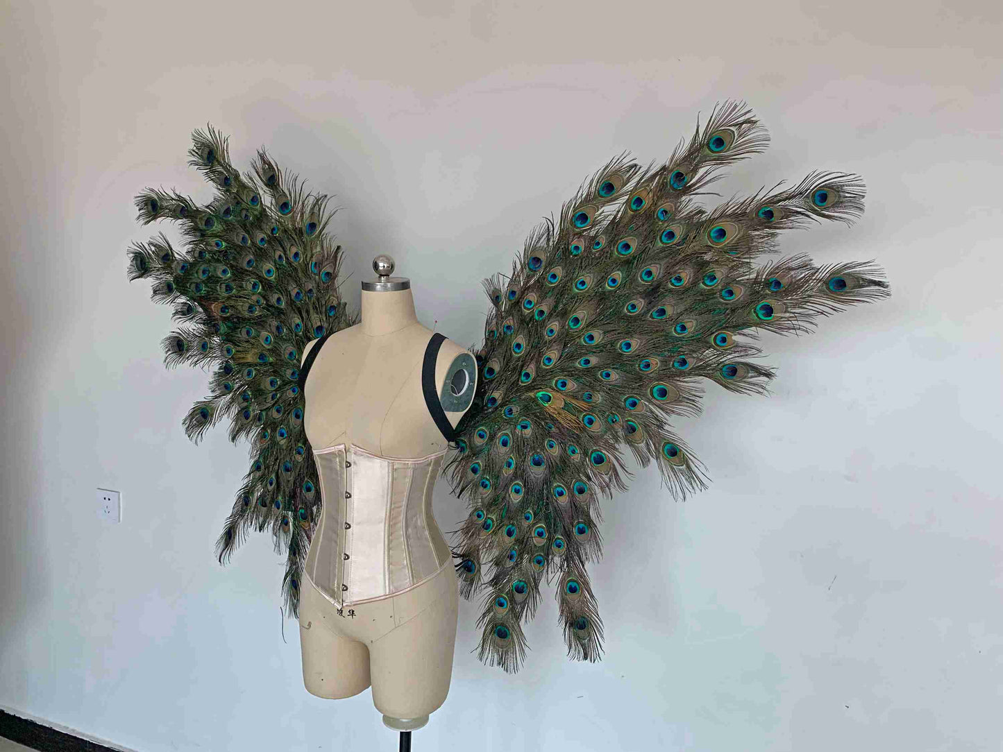 Our angel wings from the left side. Made from peacock feathers. Wings for peacock costume or fantasy costume. Suitable for photoshoots.