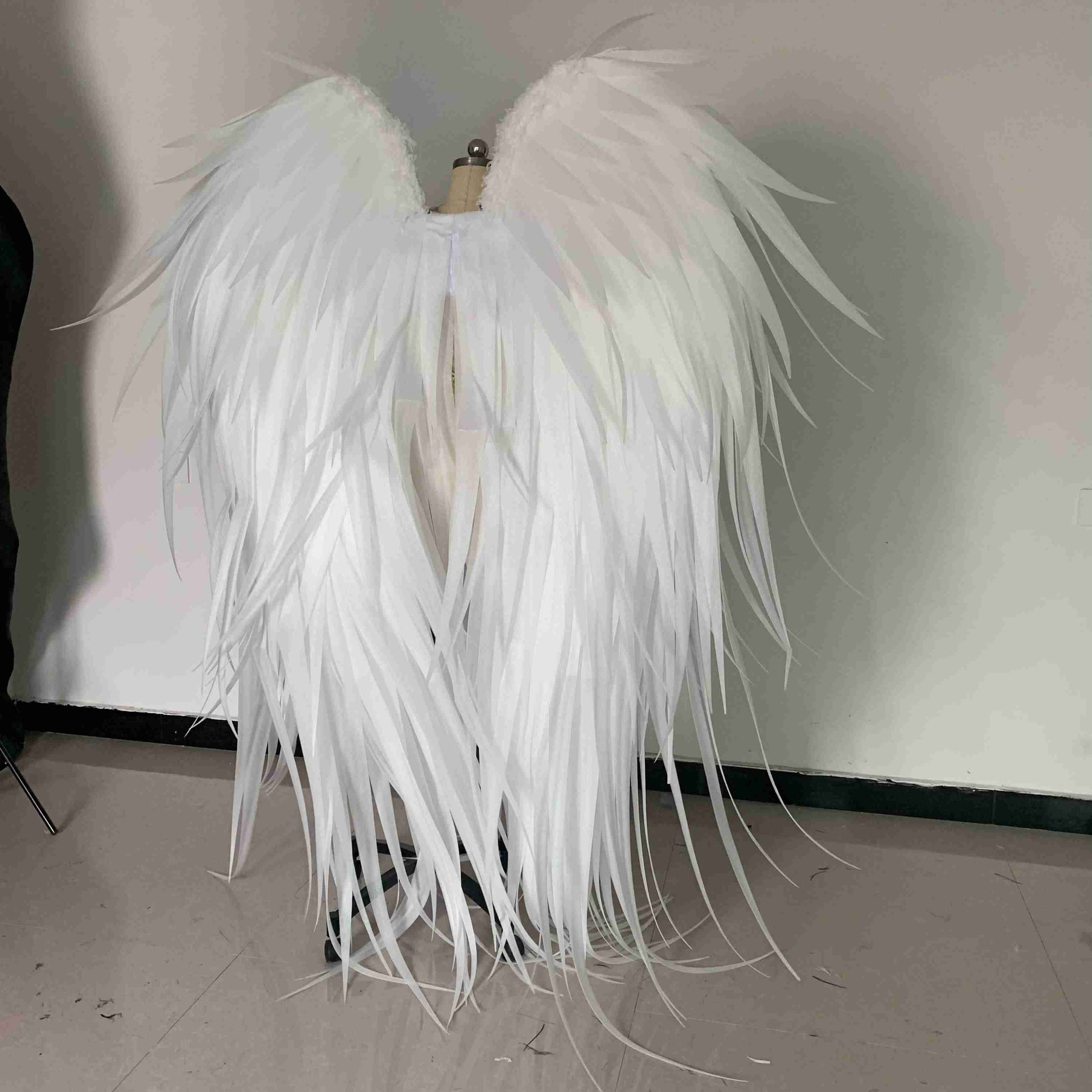 Our white angel wings from the back. Made from pearl cotton foam and some goose feathers. Wings for angel costume. Suitable for photoshoots.