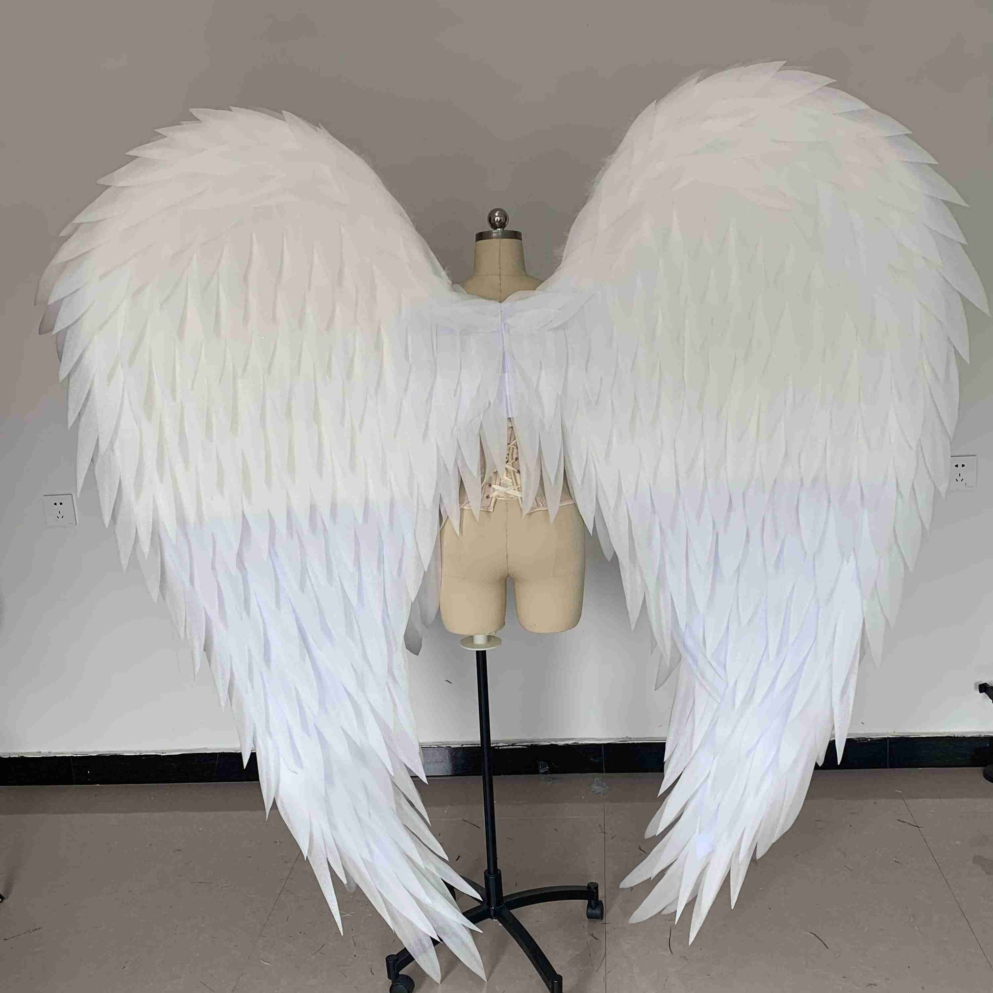 Our white angel wings from the back. Made from pearl cotton foam. Wings for angel costume. Suitable for photoshoots.