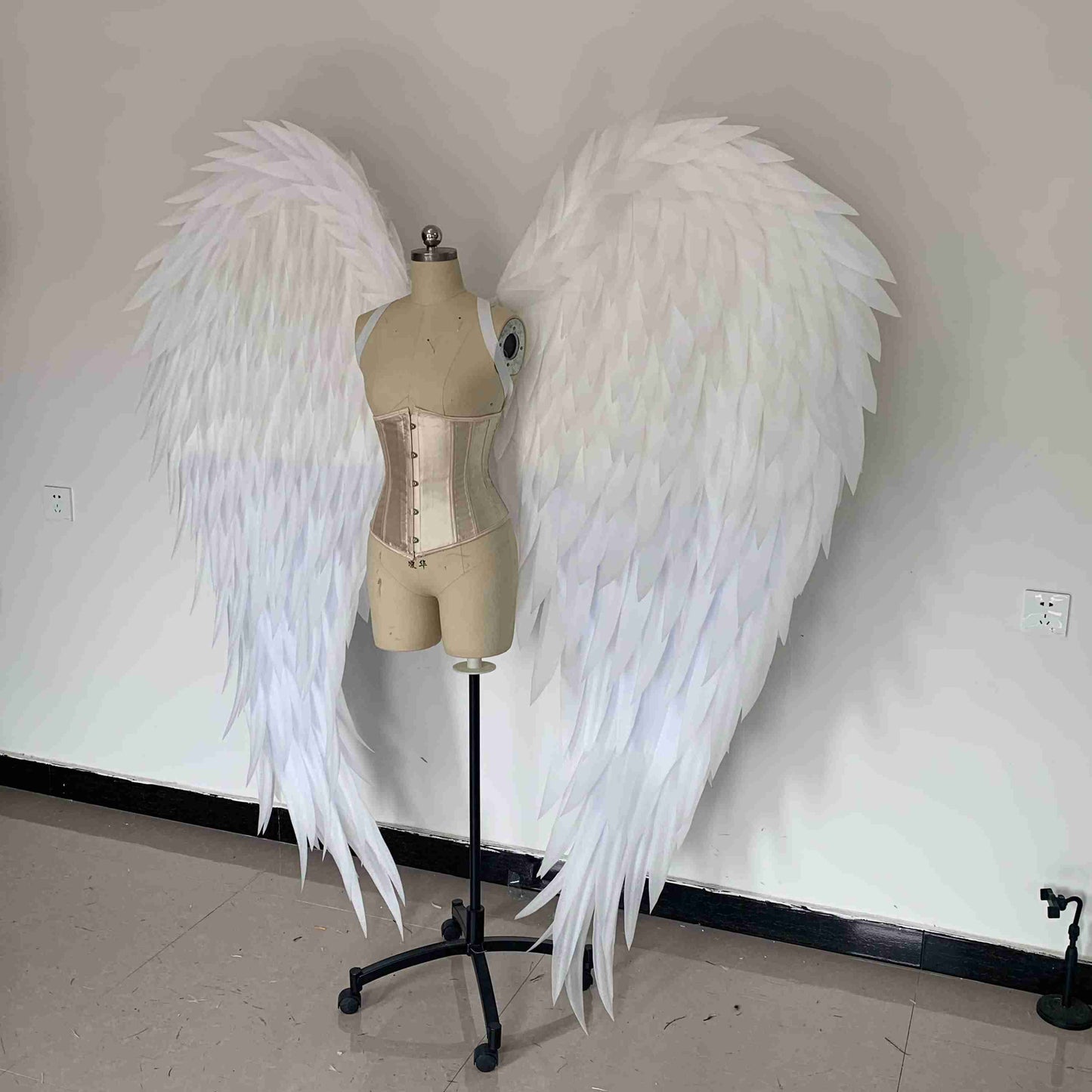Our white angel wings from the left side. Made from pearl cotton foam. Wings for angel costume. Suitable for photoshoots.