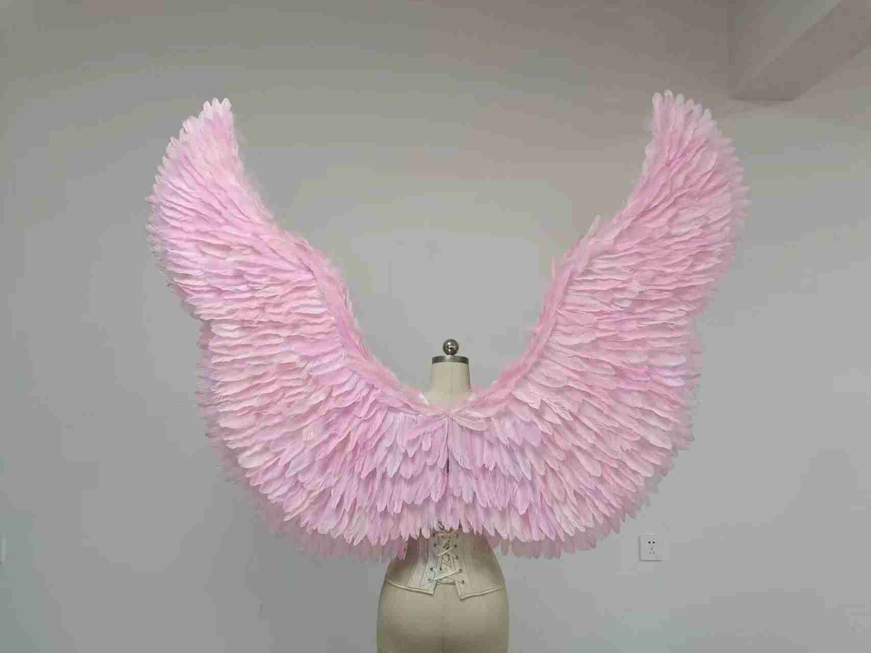 Our pink color angel wings from the back. Made from goose feathers. Wings for the devil or angel costume. Suitable for photoshoots.