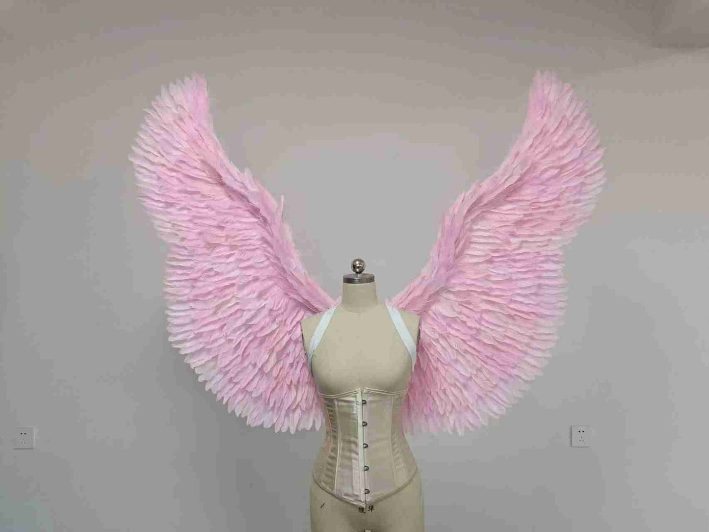 Our pink color angel wings from the front. Made from goose feathers. Wings for the devil or angel costume. Suitable for photoshoots.