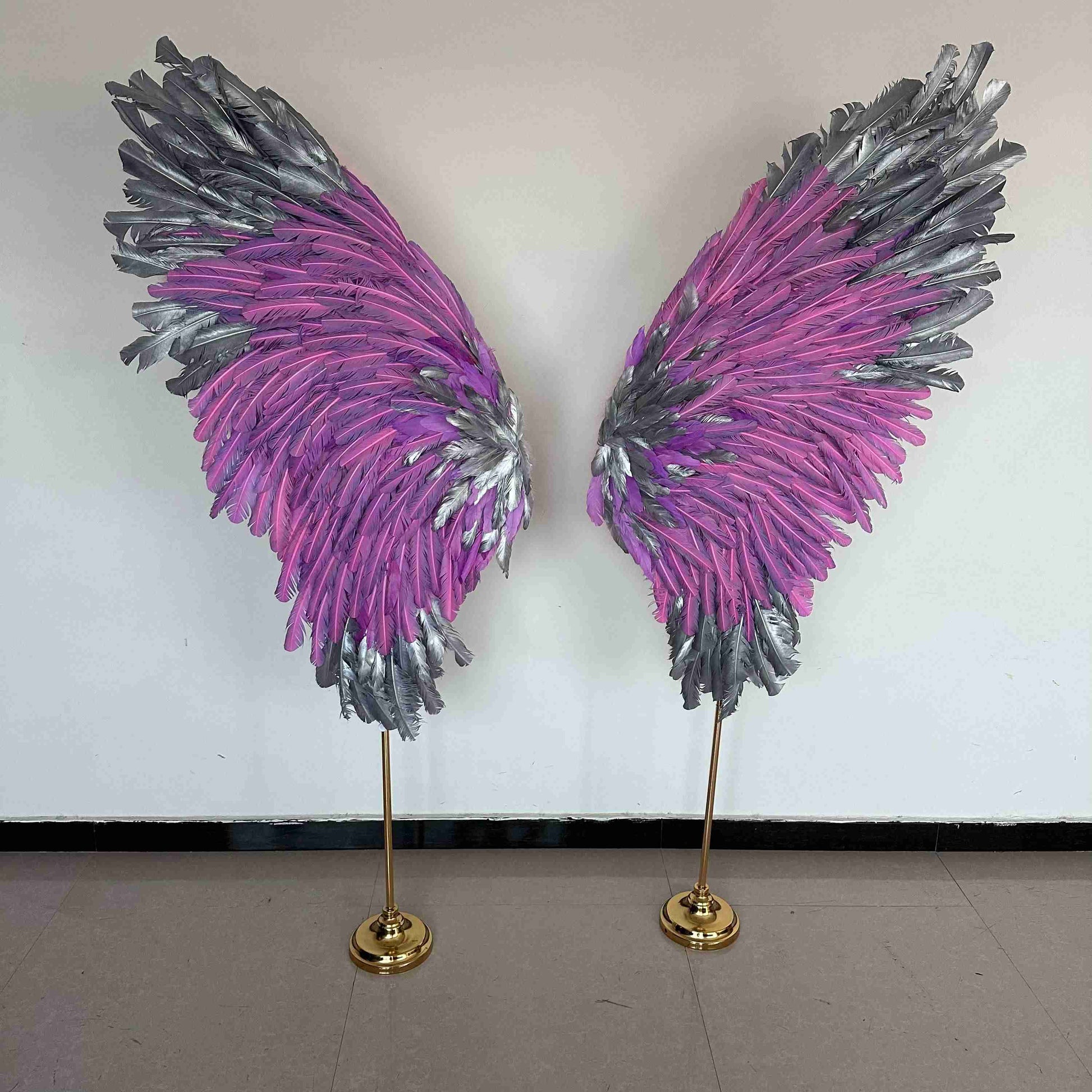 Our silver pink angel wings on poles from the front. Made from goose feathers. Wings for decoration. Suitable for restaurant, cafe, night club, event decorations.