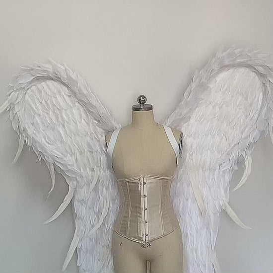 Our white color angel wings video. Made from goose feathers. Wings for the devil or angel costume. Suitable for photoshoots.