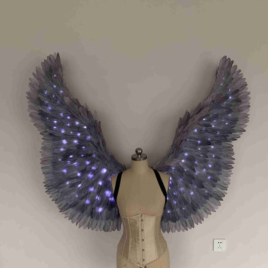 Our purple color angel wings from the front. Made from goose feathers with LED lights inside. Wings for angel costume. Suitable for photoshoots.