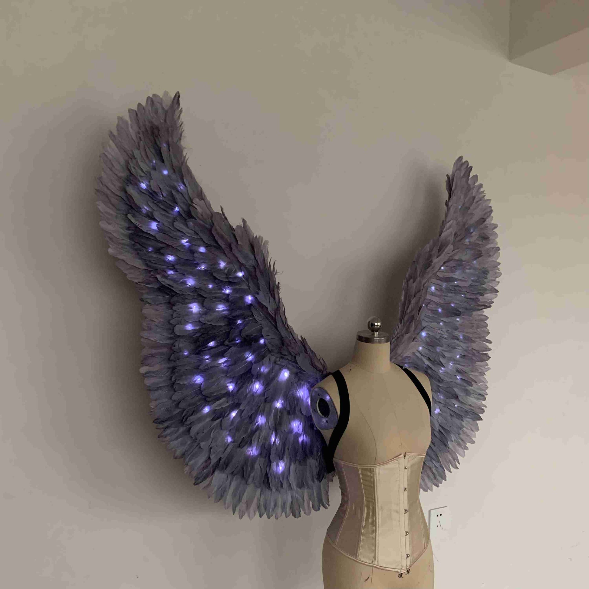 Our purple color angel wings from the right side. Made from goose feathers with LED lights inside. Wings for angel costume. Suitable for photoshoots.
