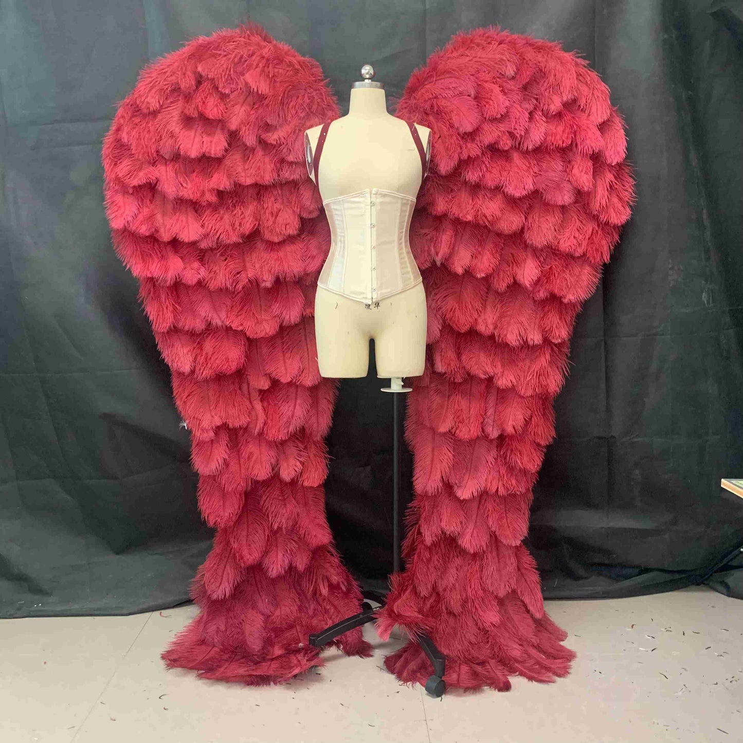 Our luxury red angel wings from the front. Made from ostrich feathers. Wings for angel costume. Suitable for photoshoots especially for boudoirs.