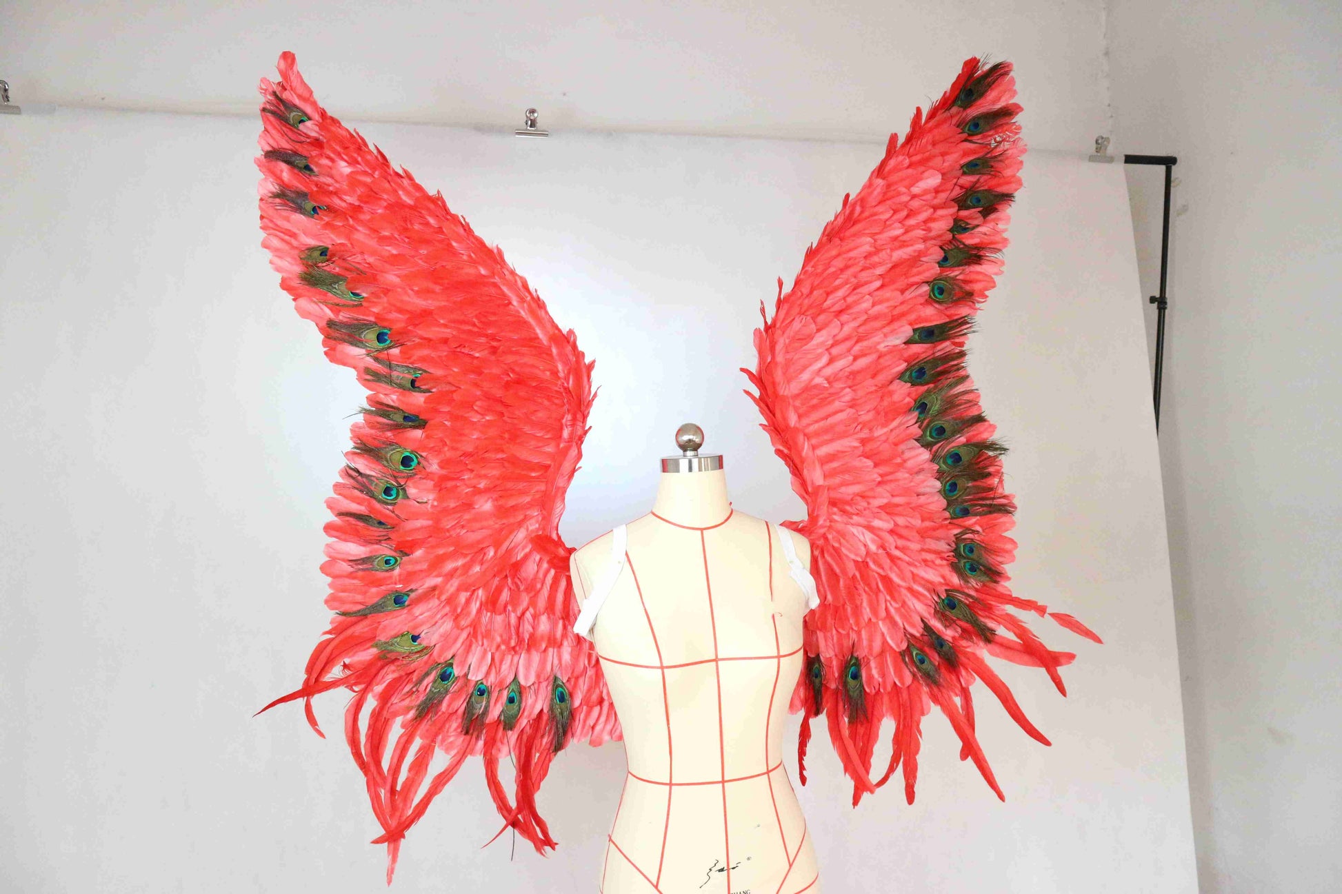 Our red peacock angel wings from the right side. Made from goose feathers and peacock feathers. Wings for angel wings costume. Suitable for photoshoots.