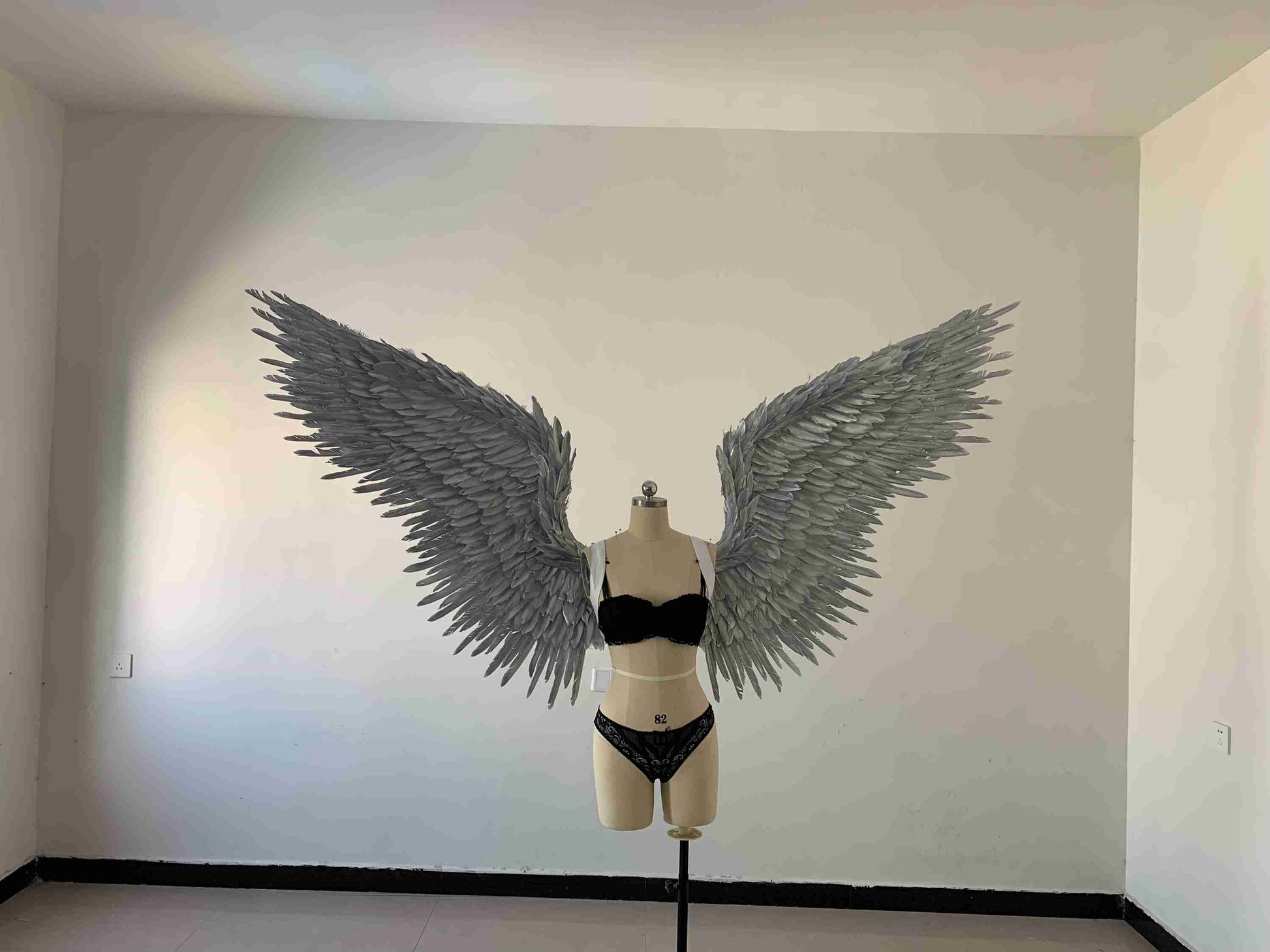Our silver color angel wings from the front. Made from goose feathers. Wings for angel costume or devil costume. Suitable for photoshoots.