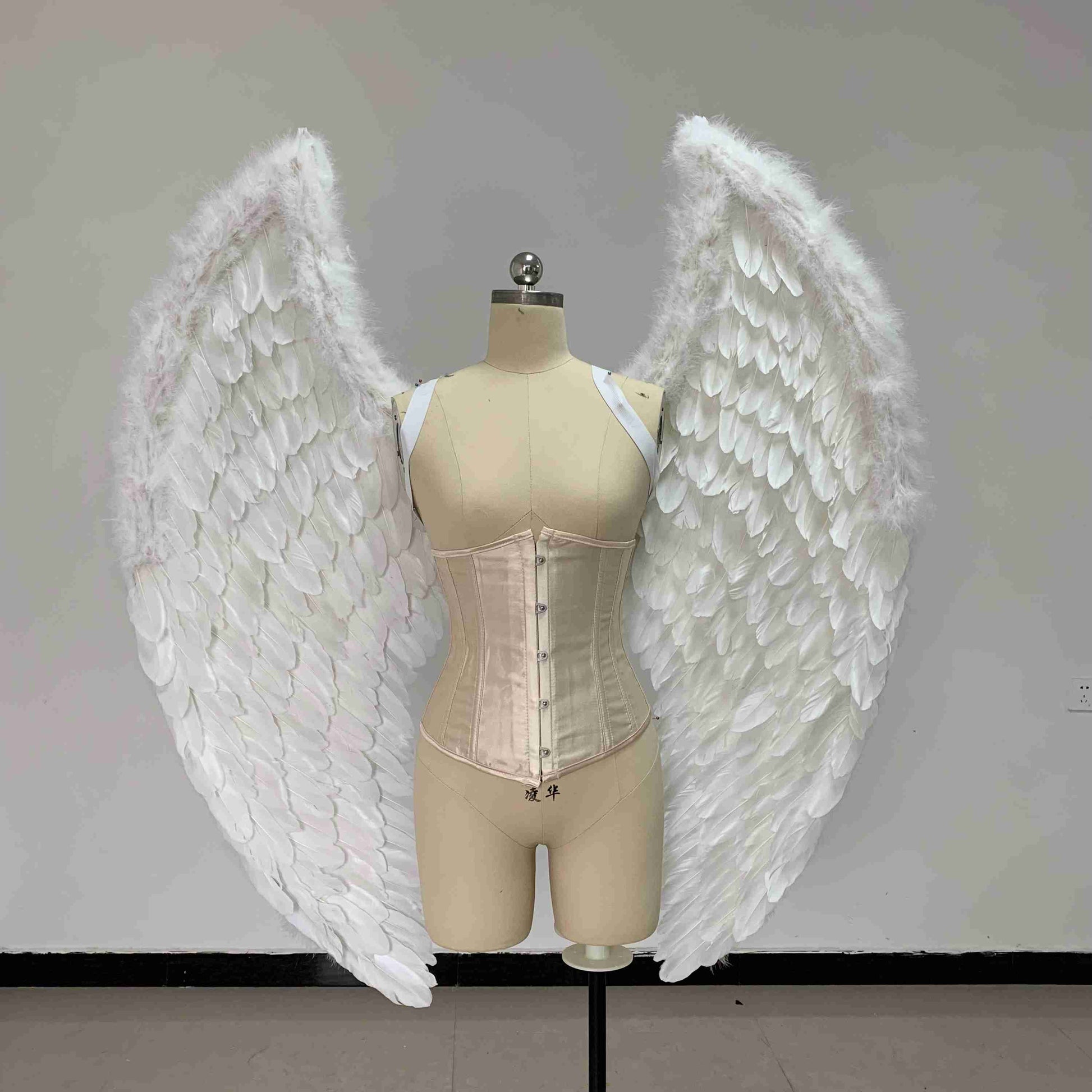 Our small white color angel wings from the front. Made from goose feathers. Wings for angel costume. Suitable for photoshoots.