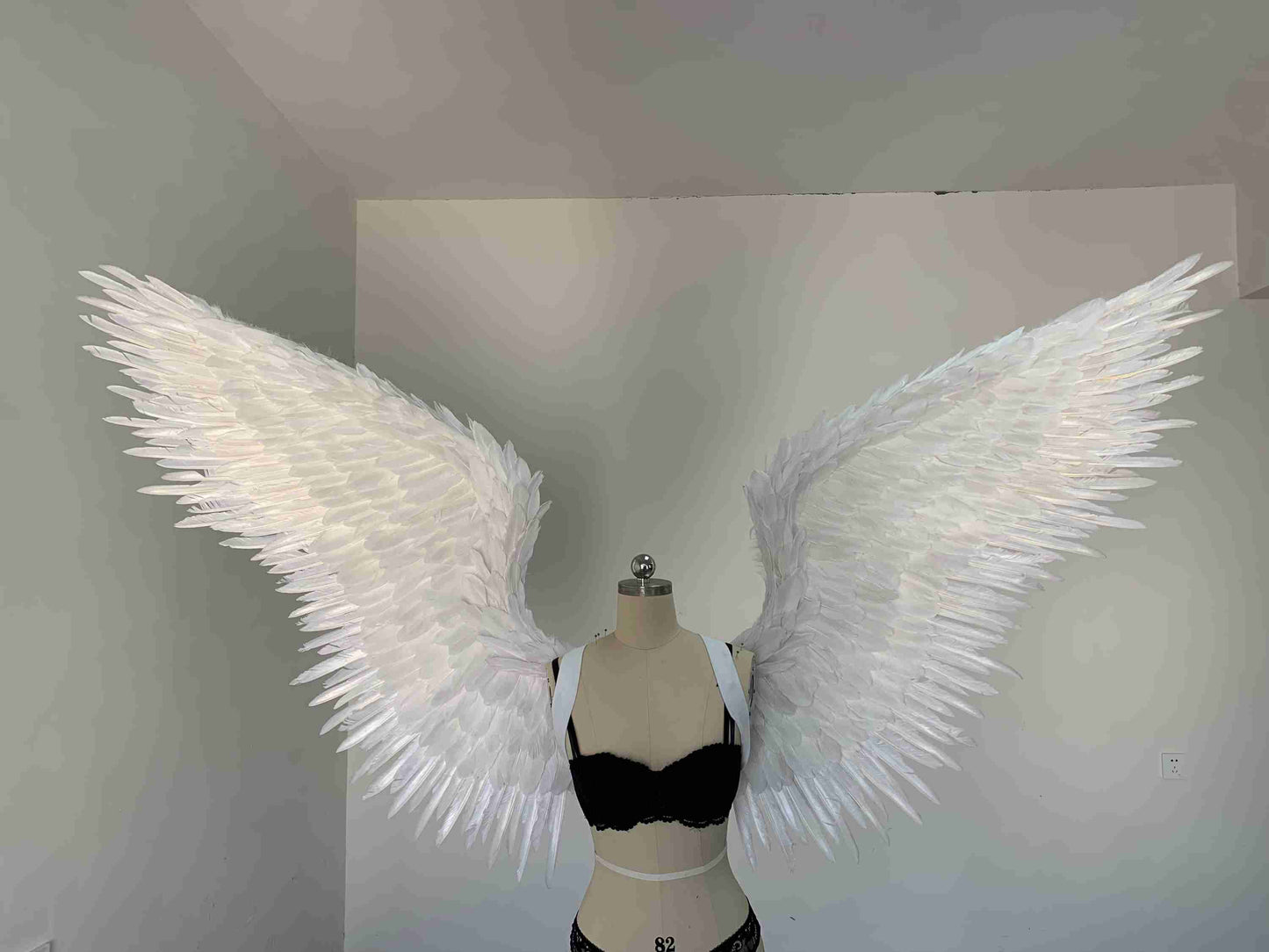 Our white color angel wings from the front. Made from goose feathers. Wings for angel costume or devil costume. Suitable for photoshoots.