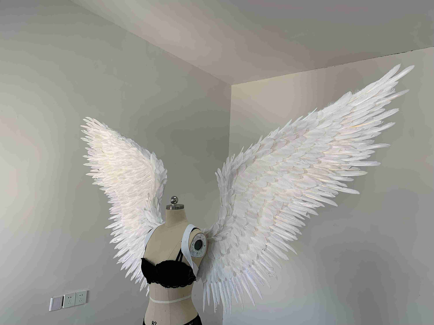Our white color angel wings from the left side. Made from goose feathers. Wings for angel costume or devil costume. Suitable for photoshoots.