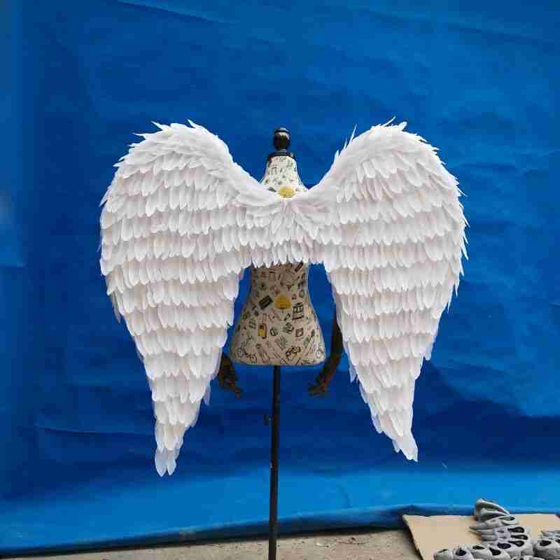 Our little white color angel wings from the back. Made from goose feathers. Wings for angel costume. Suitable for photoshoots.